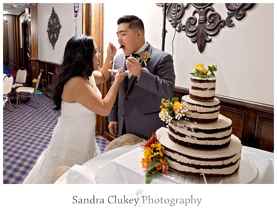 Wedding couple serve each other cake