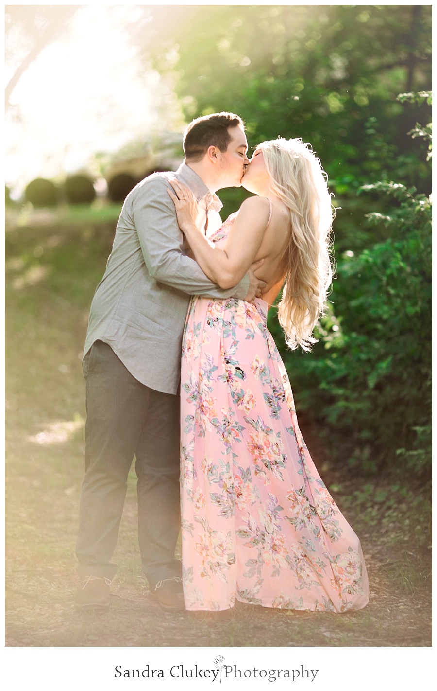 Whimsical couple kissing at sunset