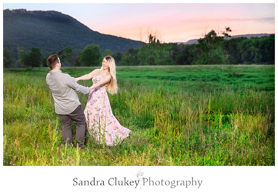 Engaged Couple dancing in sunset