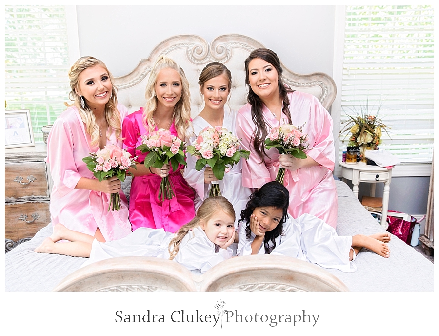 Bride on bed with bridesmaids 