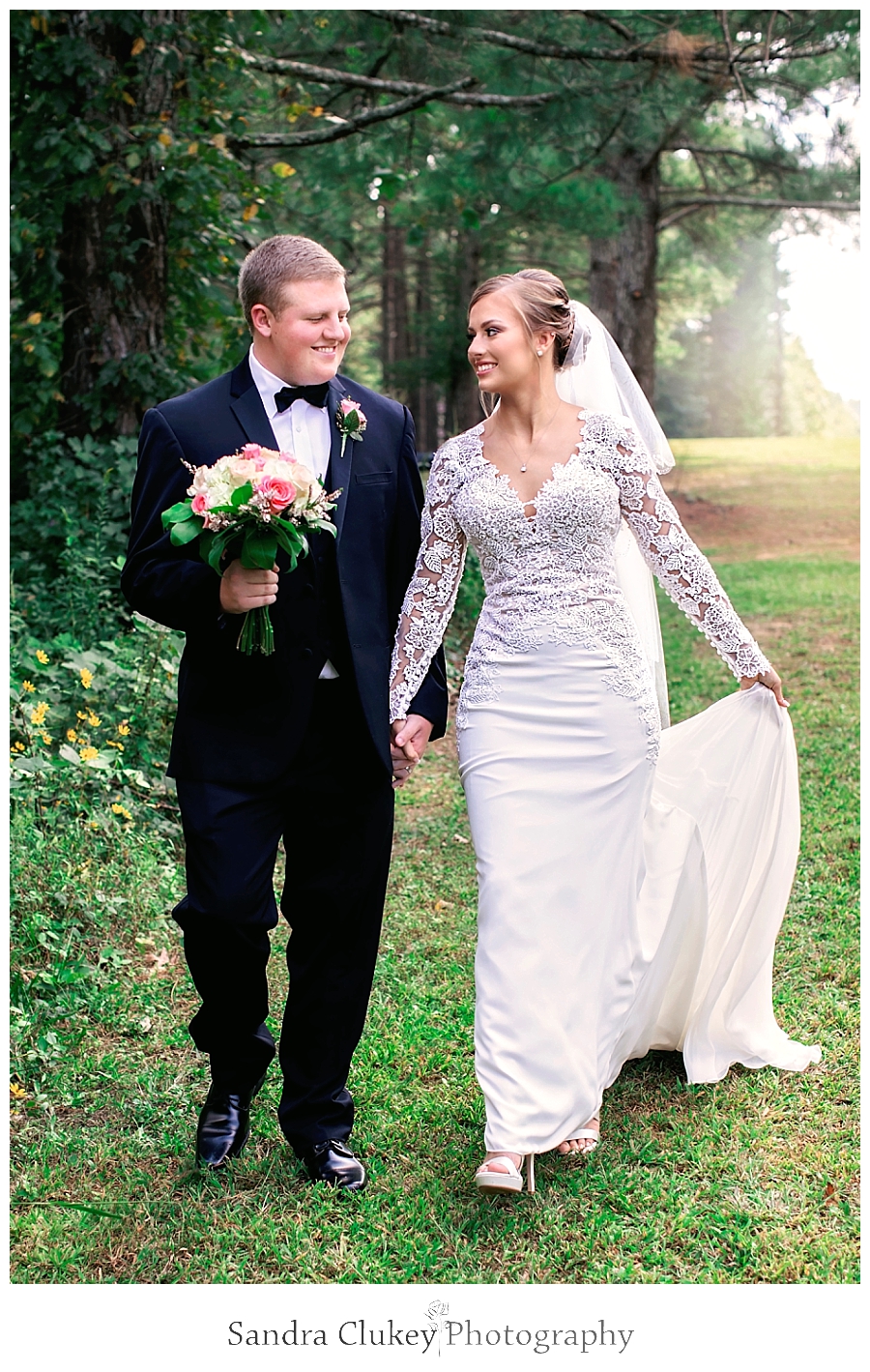  Bride and groom walking in Fletcher Park, Cleveland TN.  Copyright Sandra Clukey Photography, LLC  https://www.sandraclukeyphotography.com/ 