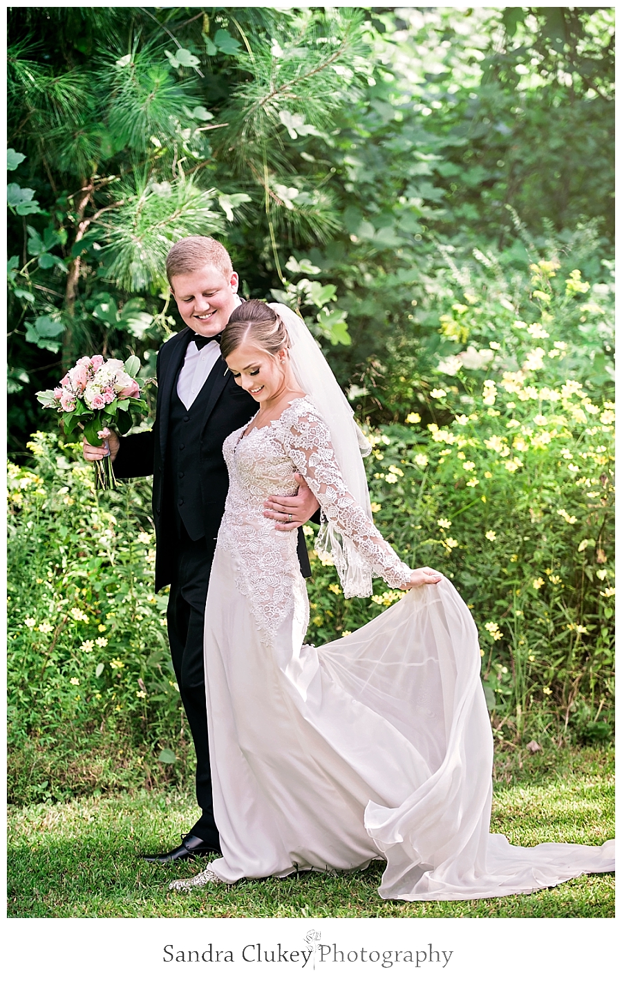  Bride and groom walking in Fletcher Park, Cleveland TN.  Copyright Sandra Clukey Photography, LLC  https://www.sandraclukeyphotography.com/ 