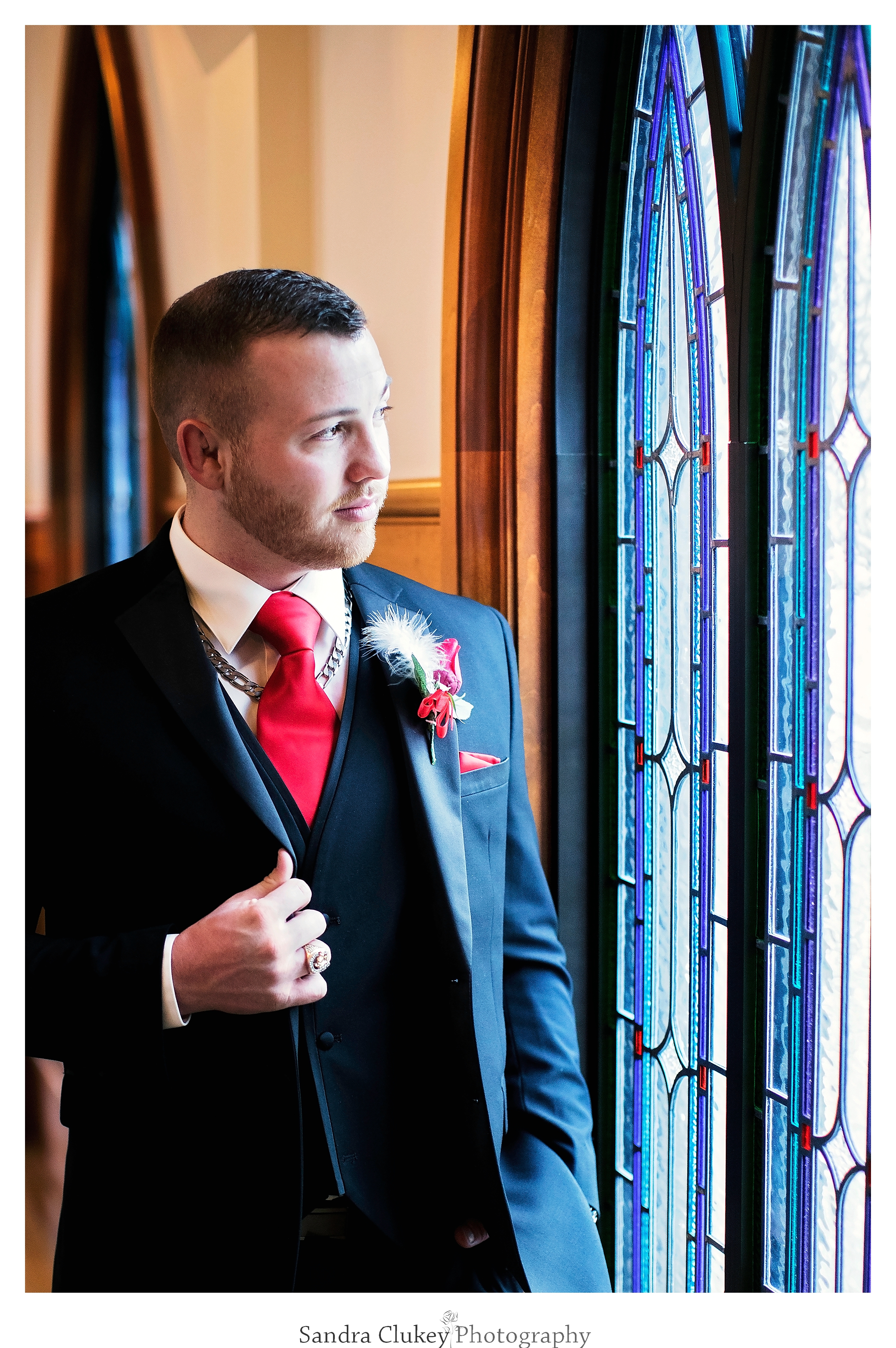 Groom at Lee University Chapel's stained glass window's