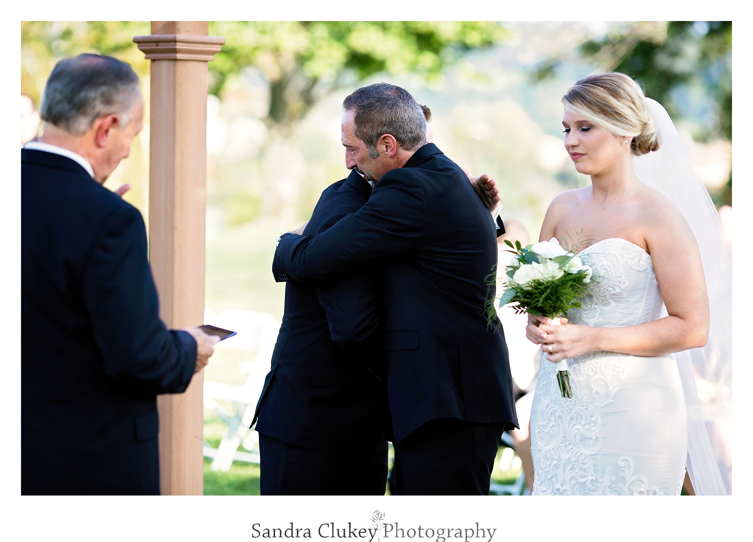 Father of the bride hugs groom at Tennessee RiverPlace, Chattanooga TN