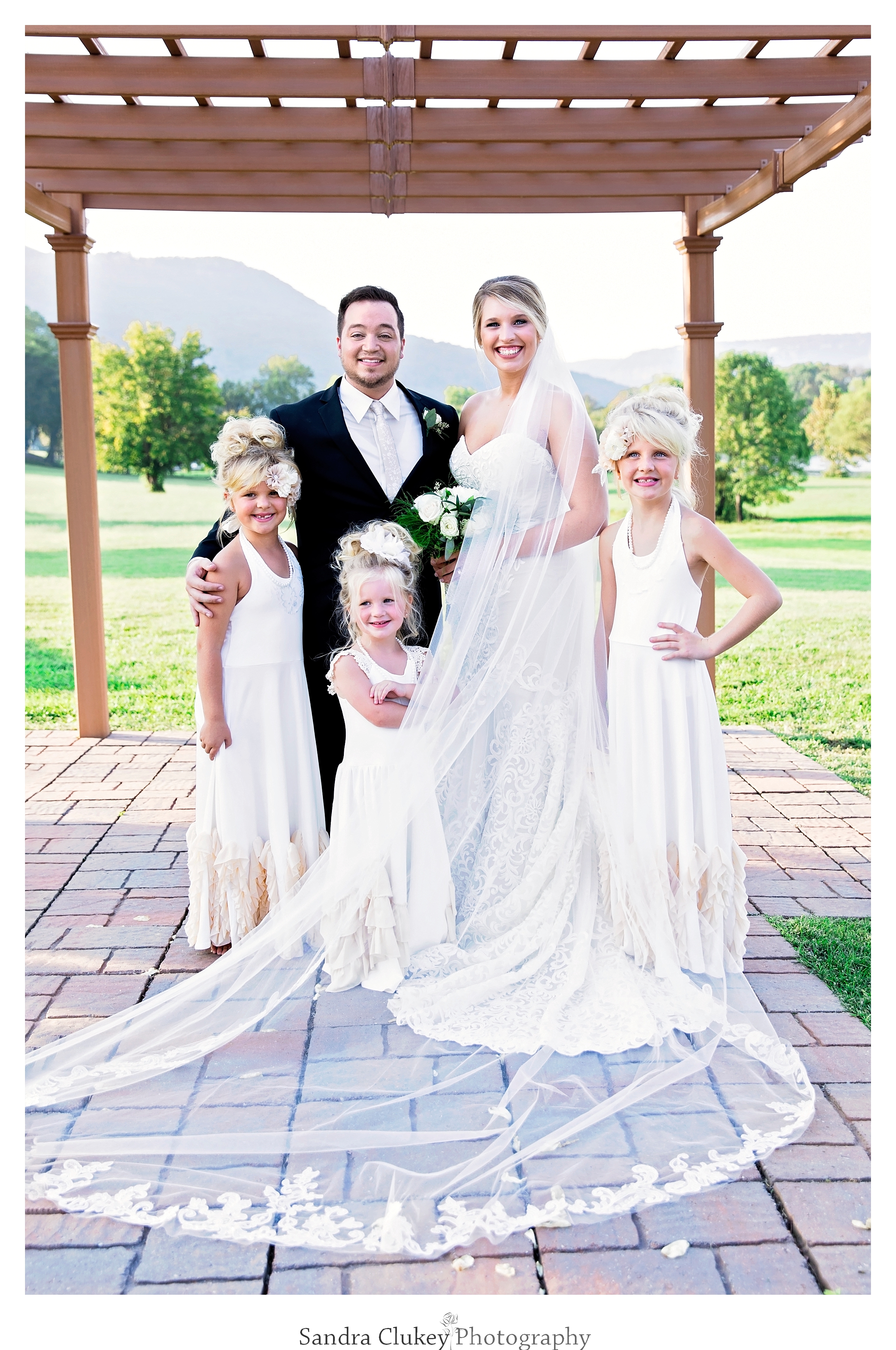 Bride and groom with flower girls at Tennessee RiverPlace, Chattanooga TN