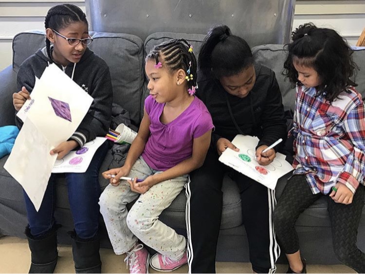 Sixth graders reading their Libro de Colores to our first graders. 