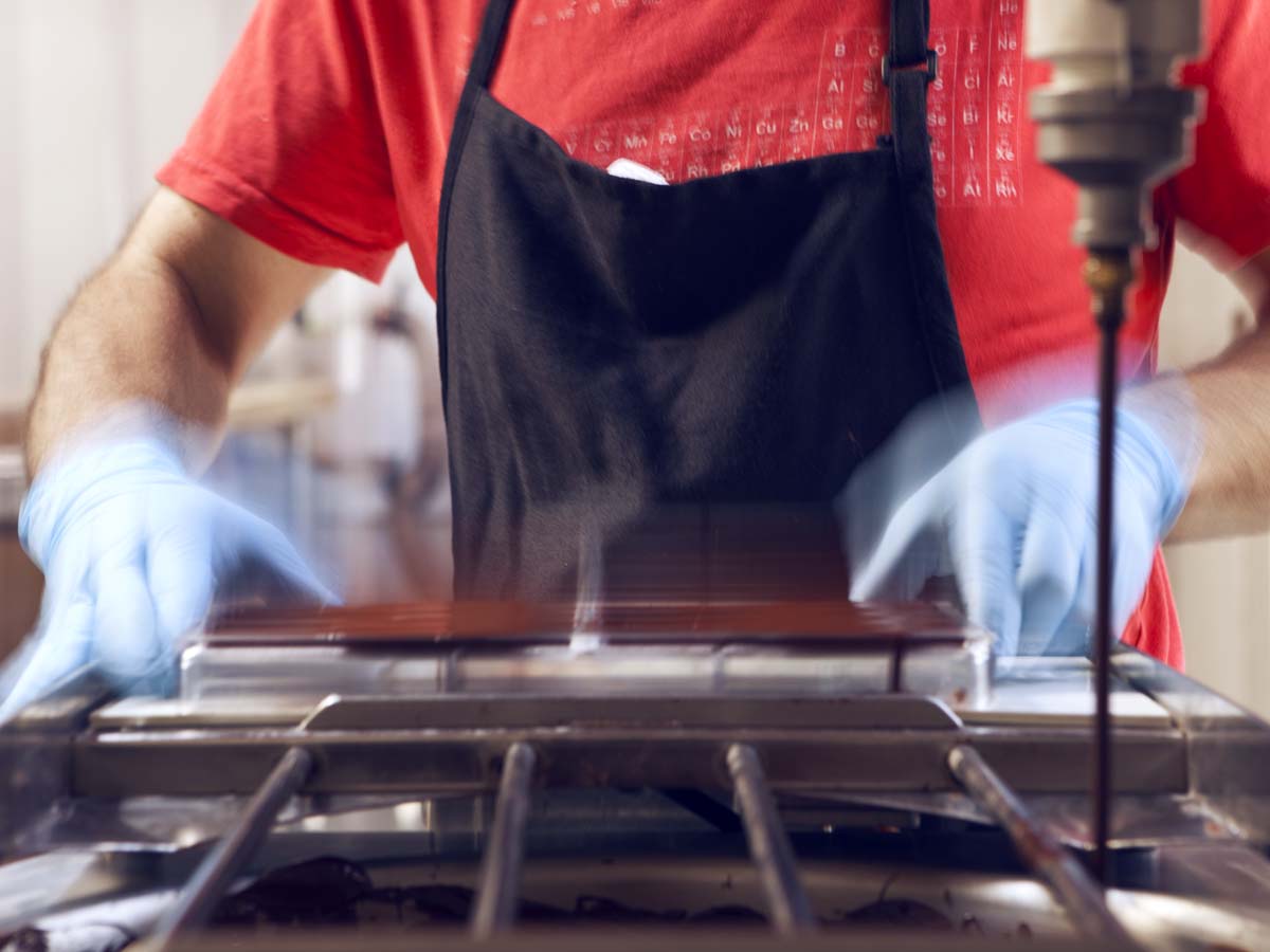  Air bubbles are also removed on the vibrating table, while also leveling the chocolate in the mold. 