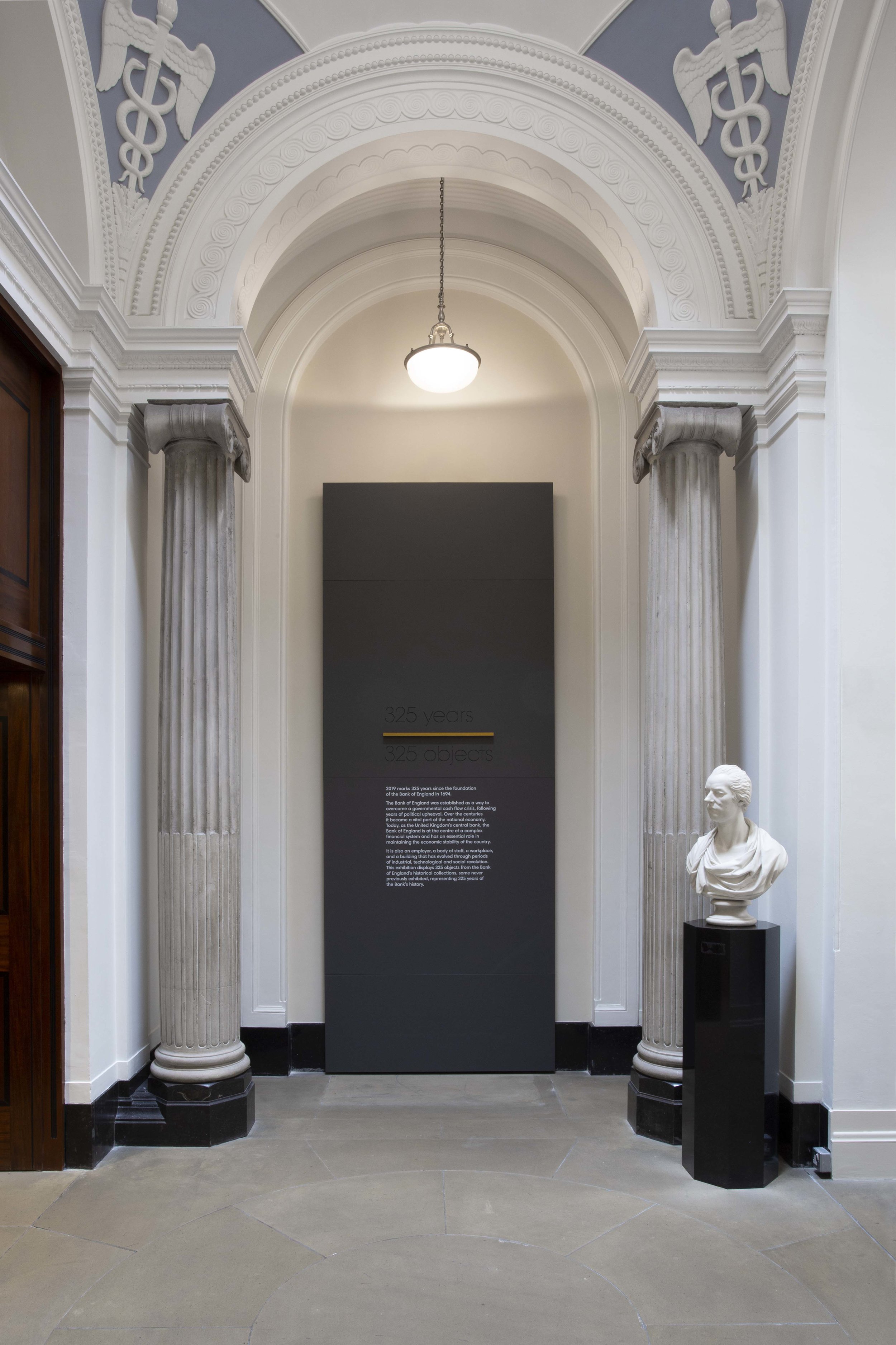 325 objects, 325 years Exhibition design, Bank of England, 2019 In collaboration with All Things Studio, we designed an exhibition celebrating the Bank of England’s 325th anniversary through 325 objects. Our design concept relies on a minimal approach to keep the main focus on the diverse range of objects. Each object has its own gold number to bring a delicate spark of light to the showcases. Large dates are engraved on the back panel helping the visitors to navigate the exhibition and adding a sophisticated sense of depth to the display.