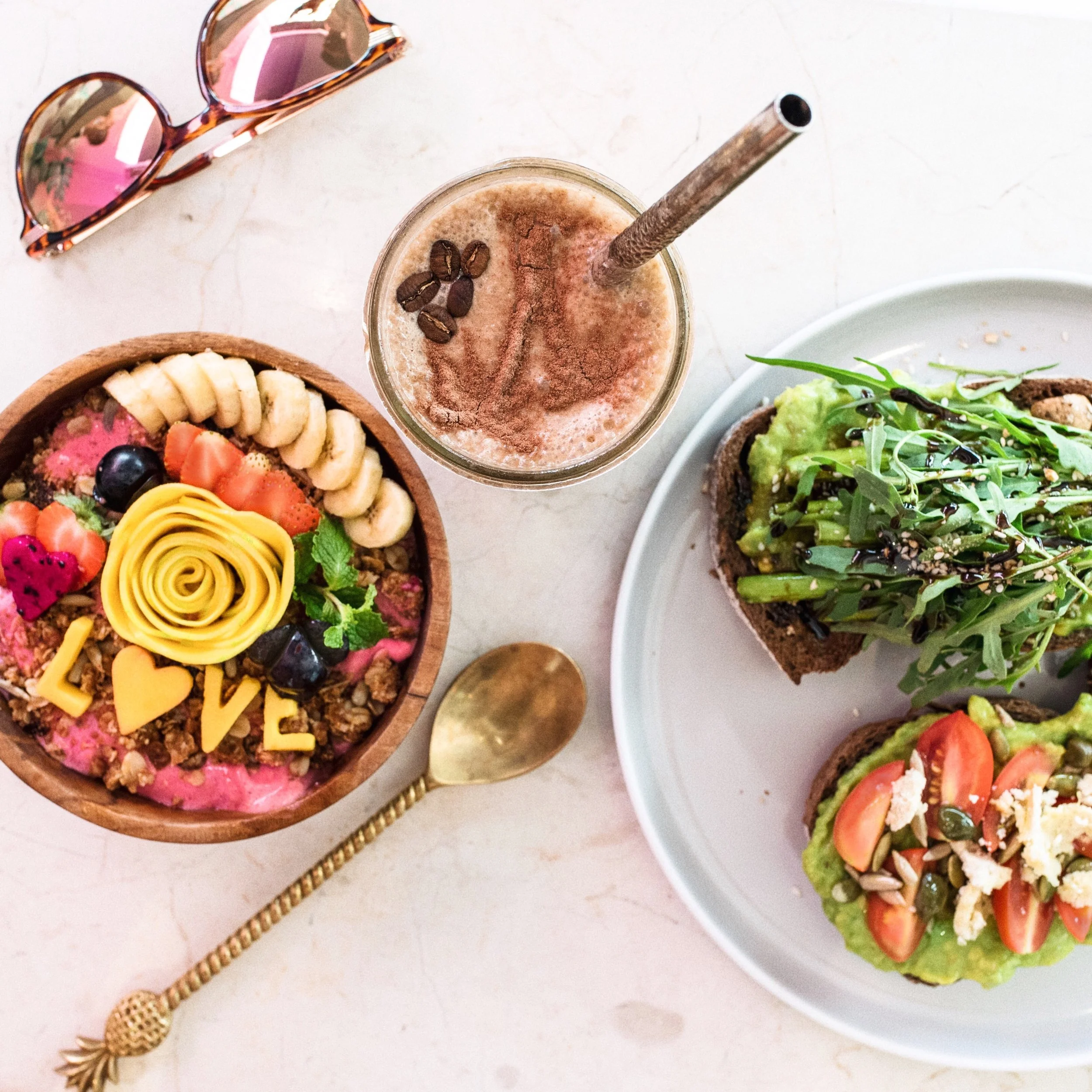 Kynd's famous smoothie bowl with a new message every time, coffee smoothie, and avocado toasts with almond feta