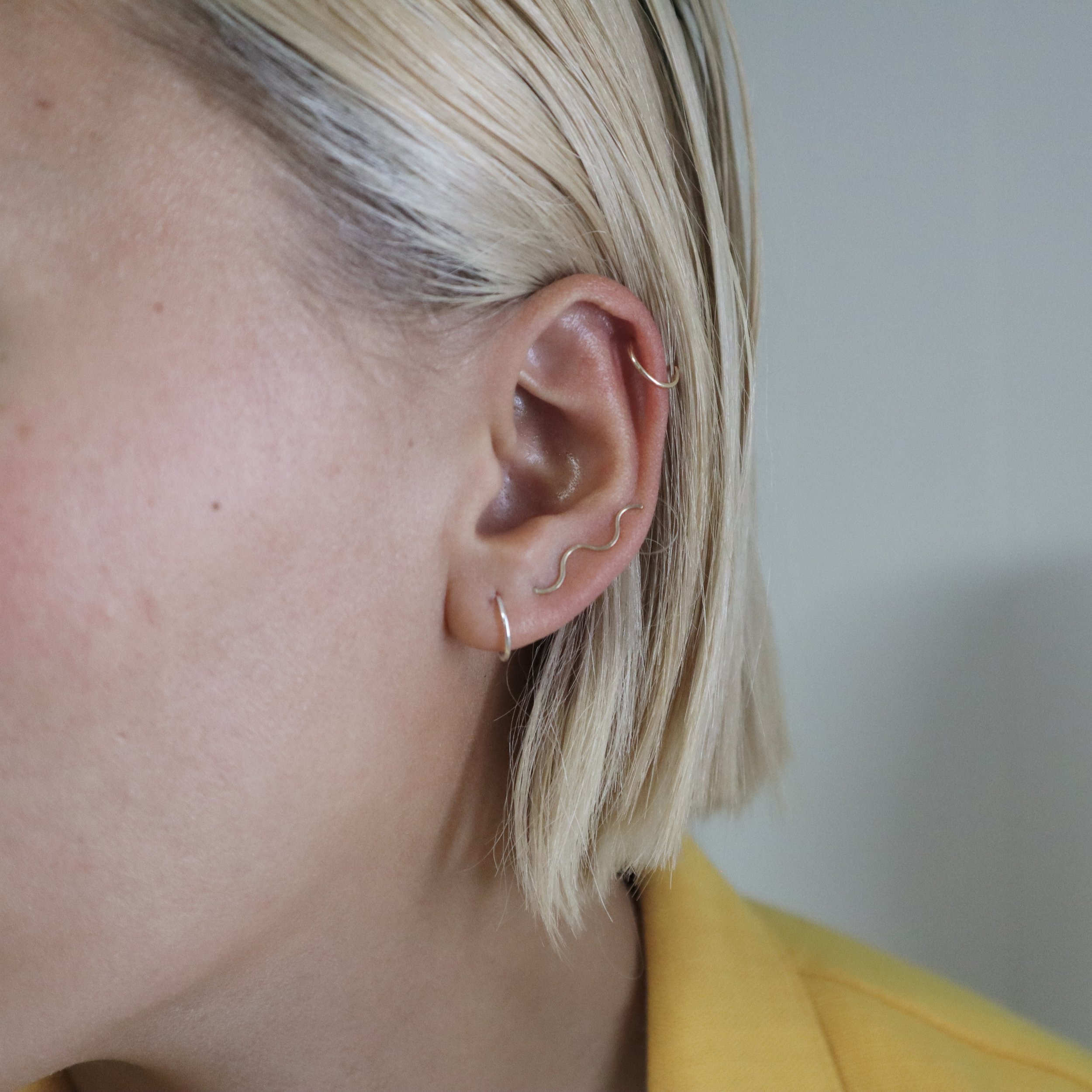 silver and gold huggie hoops with ear climber.JPG