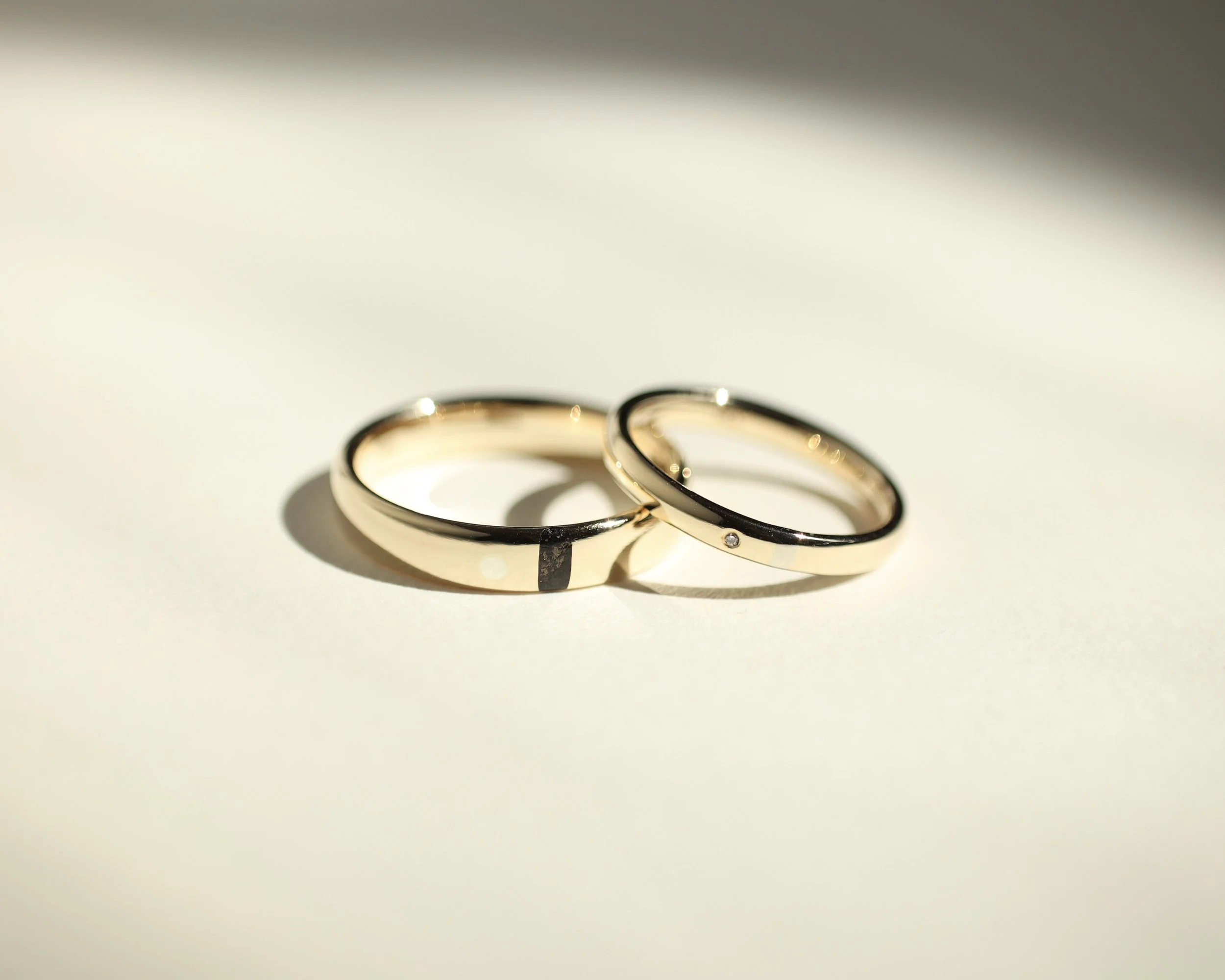 Svalbard wedding bands with diamond, coal, and white gold inlay for Ellie & Sebastian