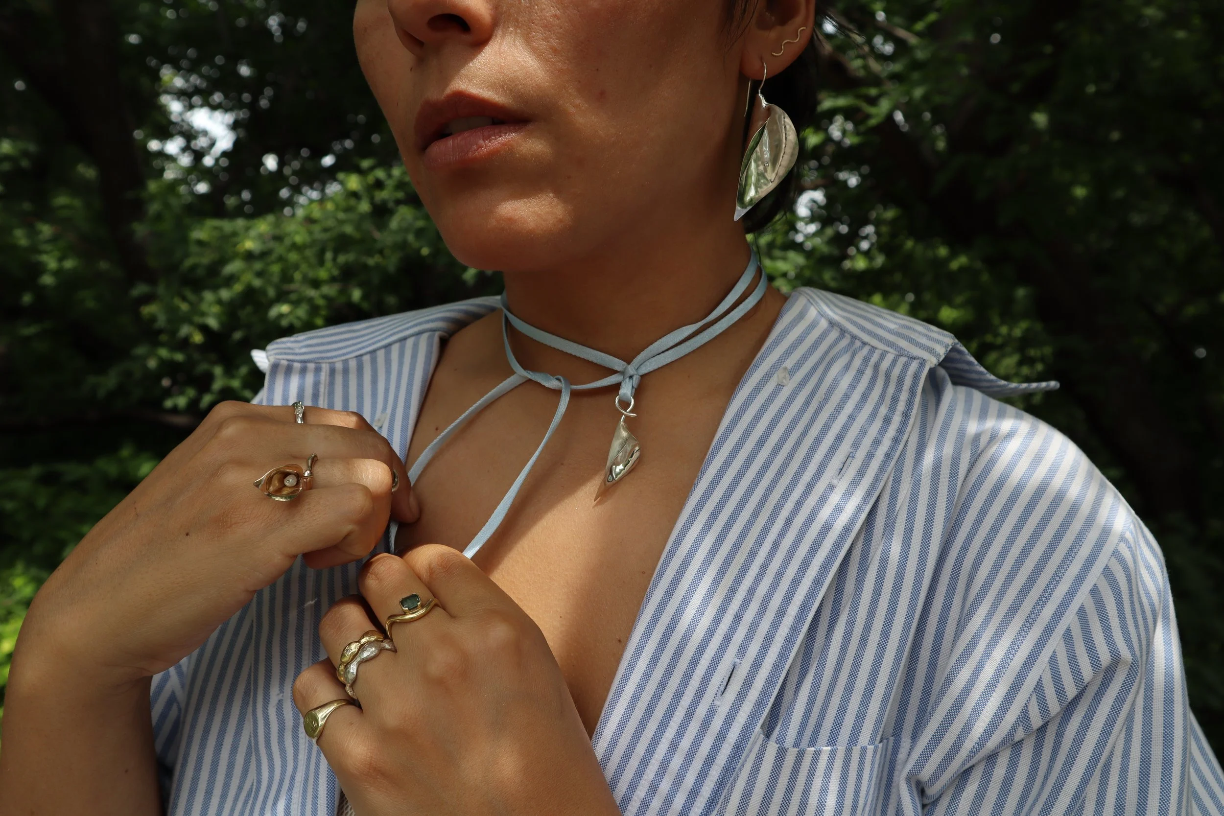 tying blue ribbon necklace.JPG