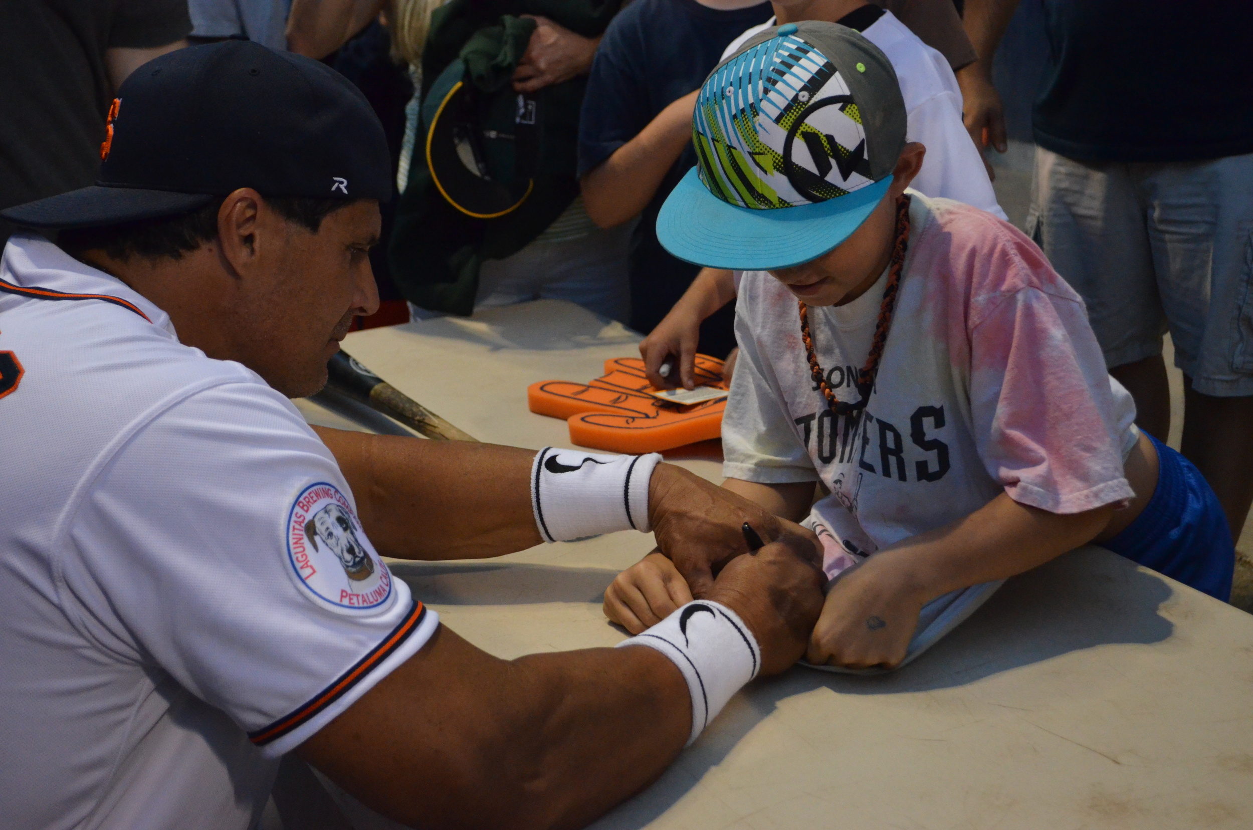 Jose Canseco signs an autograph for a young fan at Arnold Field. James Toy III/Sonoma Stompers