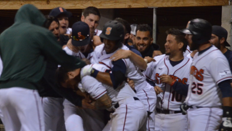 Mark Hurley is mobbed by his teammates after he scored the winning run on a wild pitch in Sonoma's come-from-behind victory on Wednesday night. Hurley scored twice on wild pitches in the game. James Toy III/Sonoma Stompers