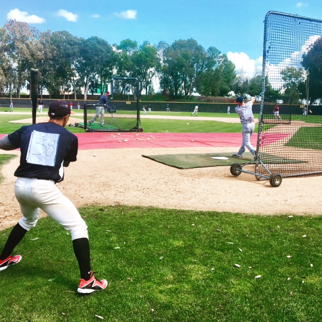 Infielder Ryan Wheat (right) taking batting practice at the Pacific Association Tryout at Los Medanos College in Pittsburg, California. 