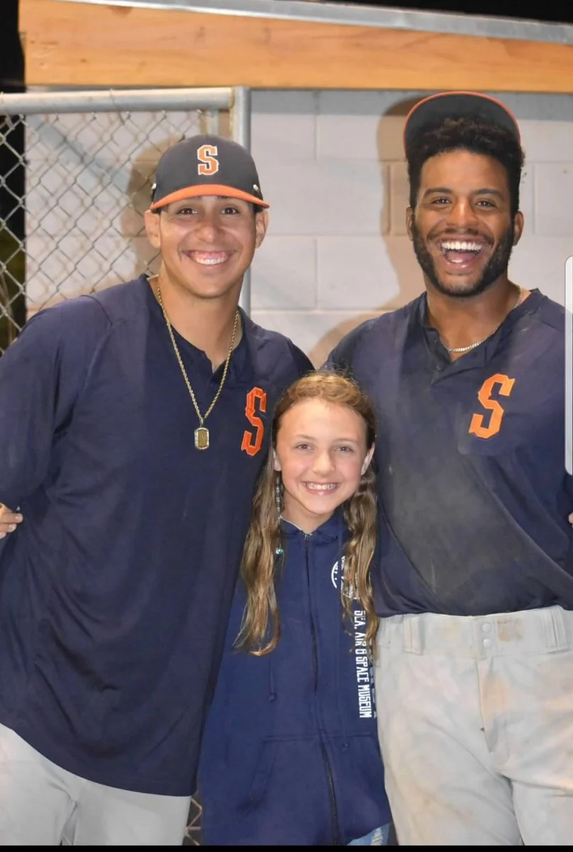 Sluggers Jacob Barfield and Dondrei Hubbard taking a photo with a fan