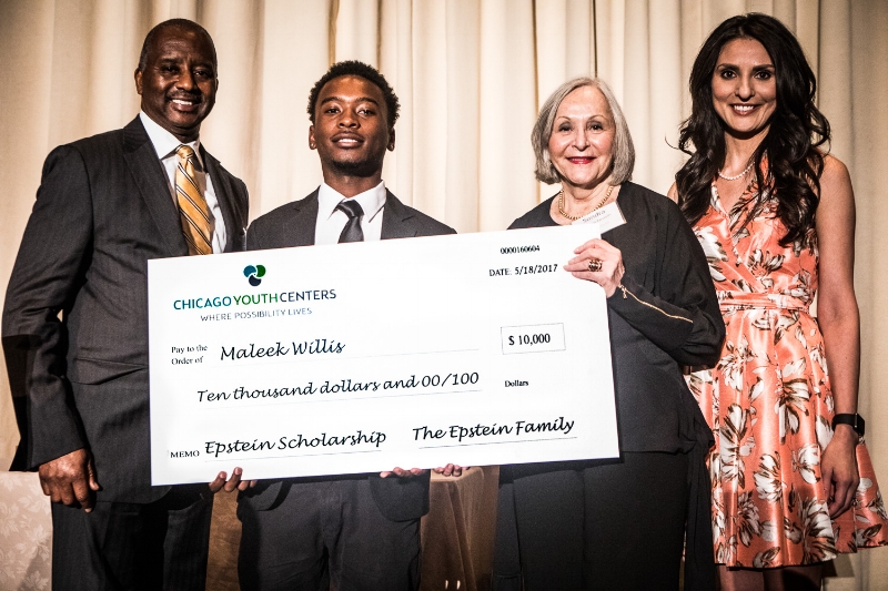 Left to right: CYC Board Member Al Reid, Epstein Scholar Maleek Willis, Sondra Berman Epstein, and Master of Ceremonies Rosa Flores during the Epstein Scholarship Award presentation. This year's $10,000 award was made possible by the Epstein Family and Rivers Casino. Al Reid and his family gave Maleek a new laptop.