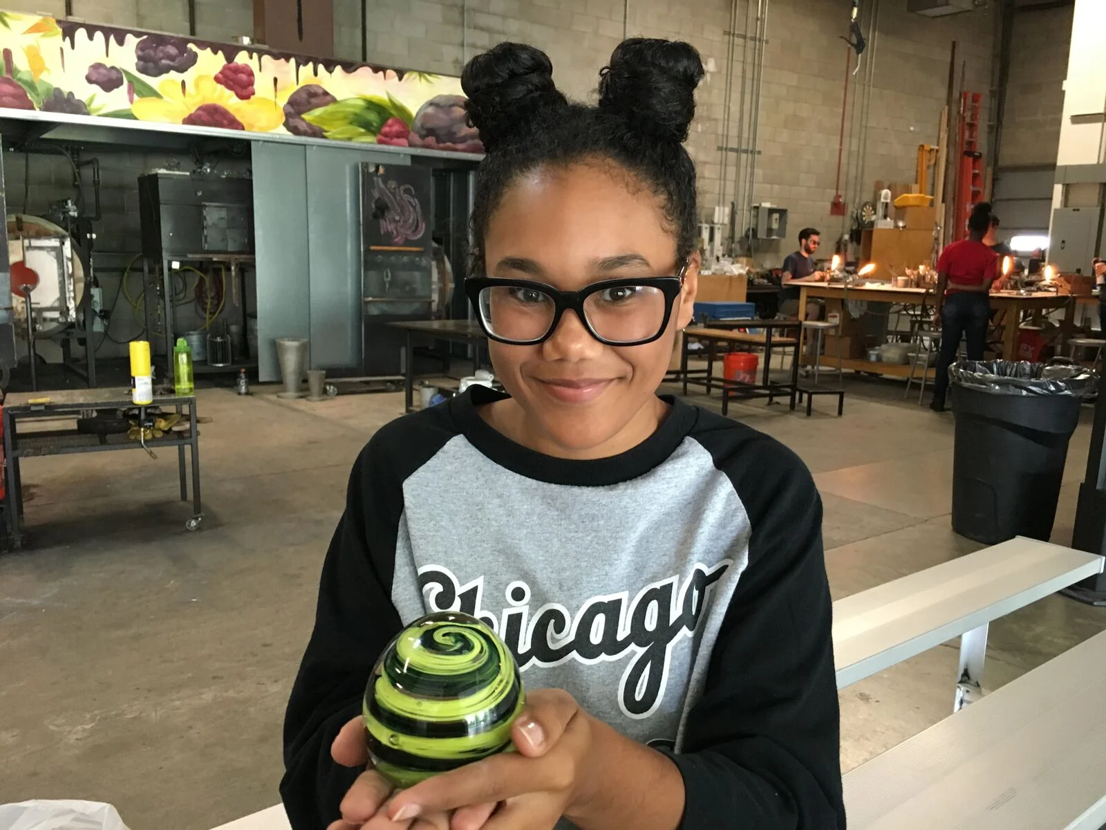 A teen from CYC-Fellowship House poses with her glass paperweight.