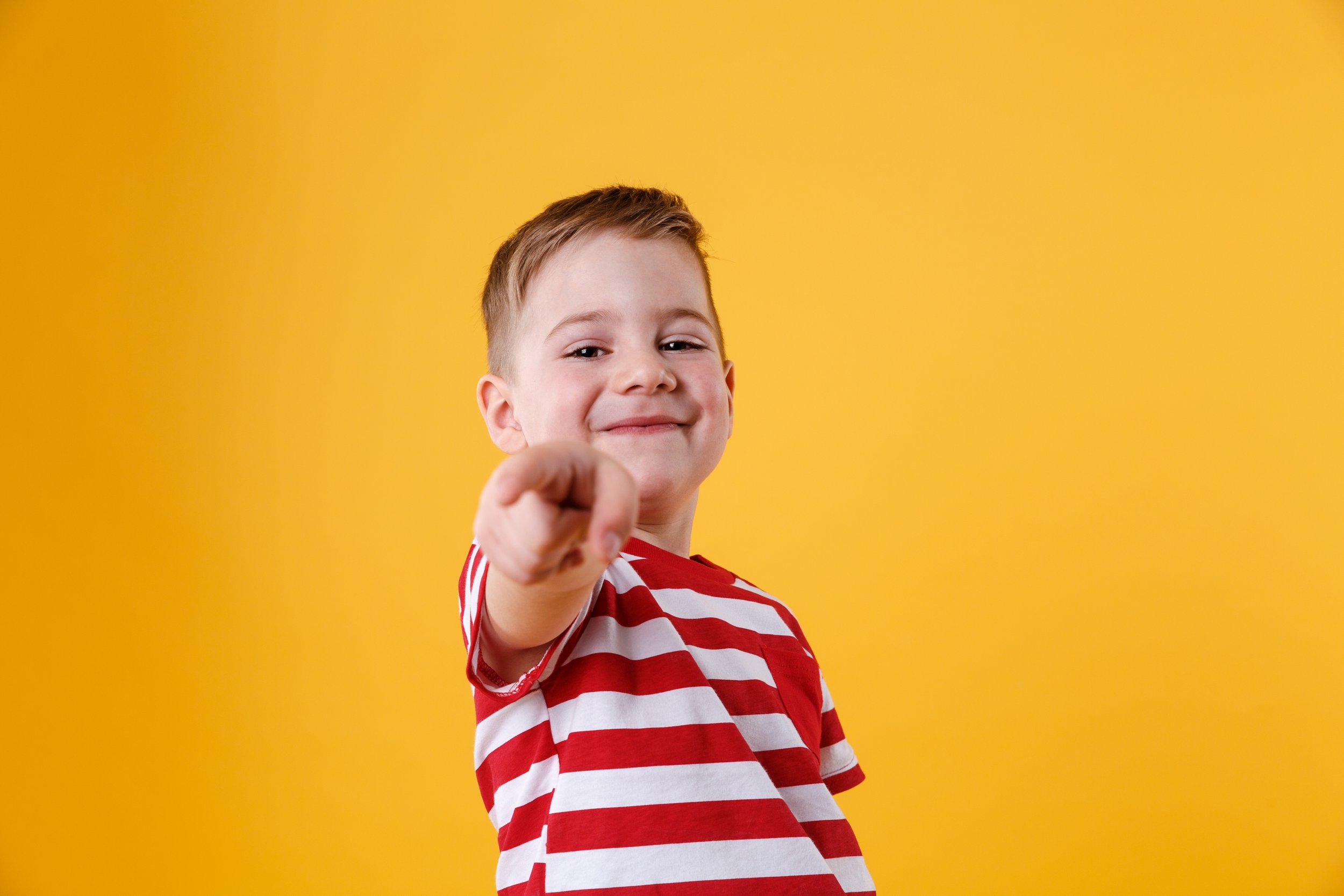 portrait-smiling-little-boy-pointing-finger.jpg