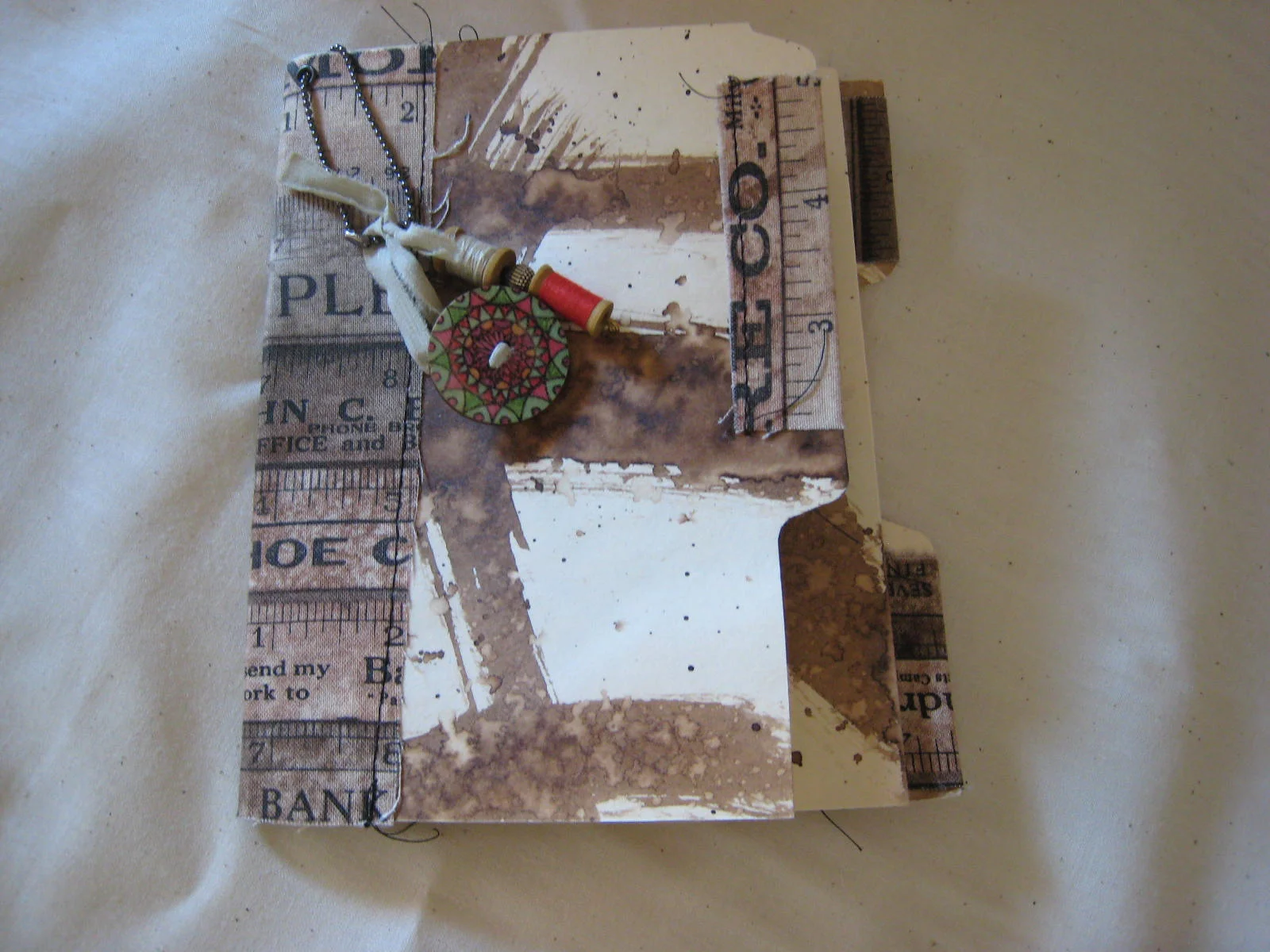Small Journal with fabric spine, tabs and embellishments