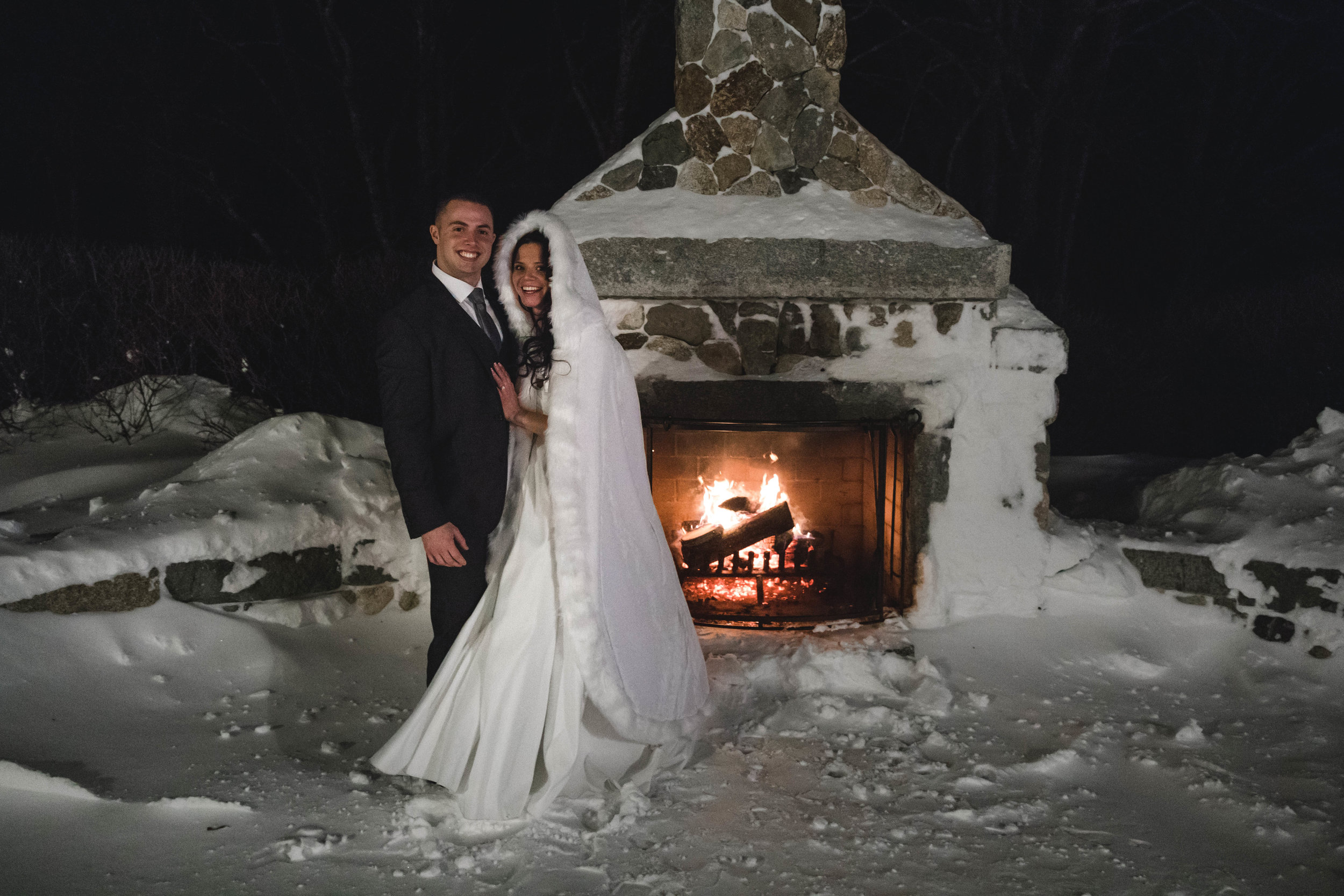 bride and groom at outdoor fireplace at Harrington Farm January wedding