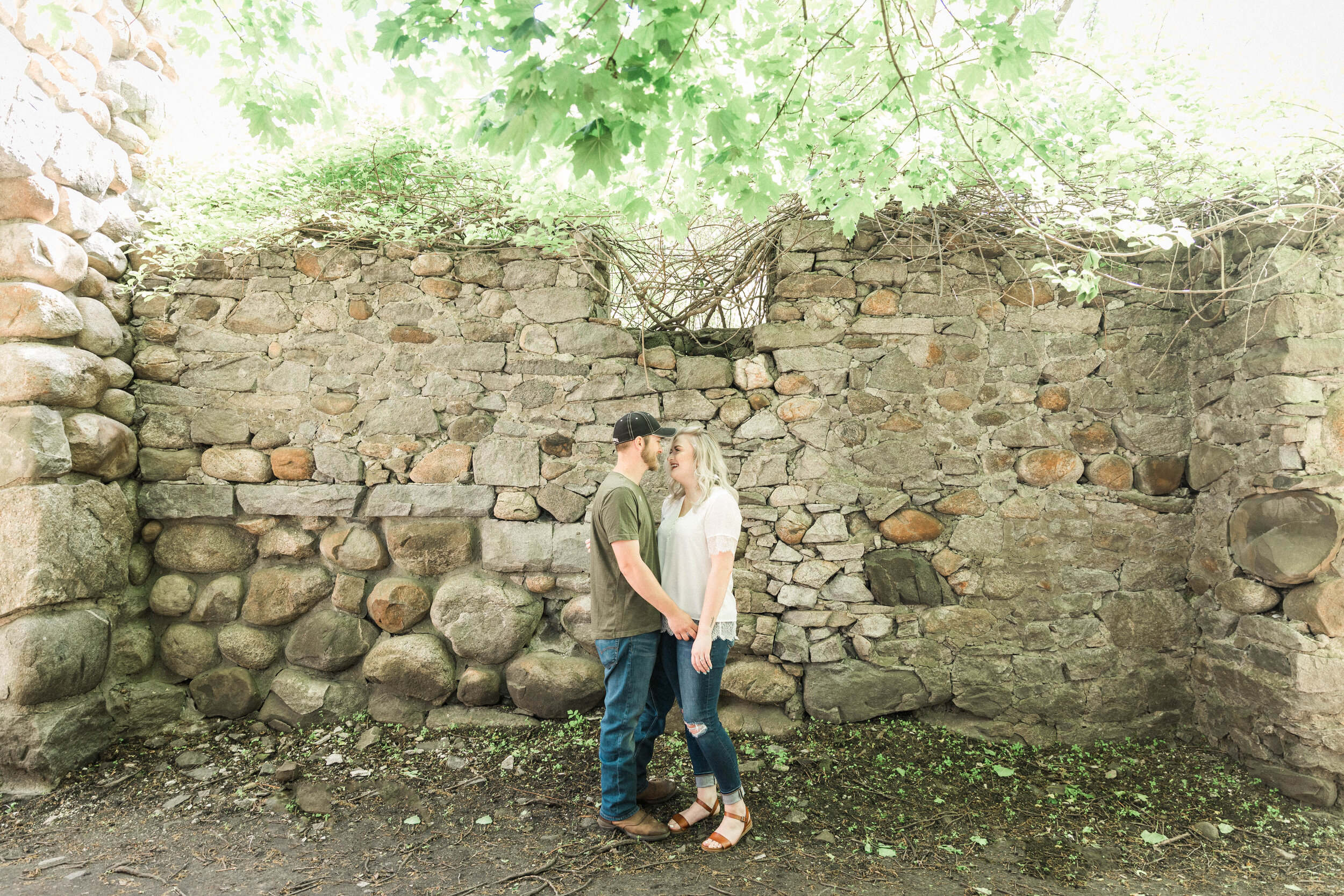 Couple in front of stone wall