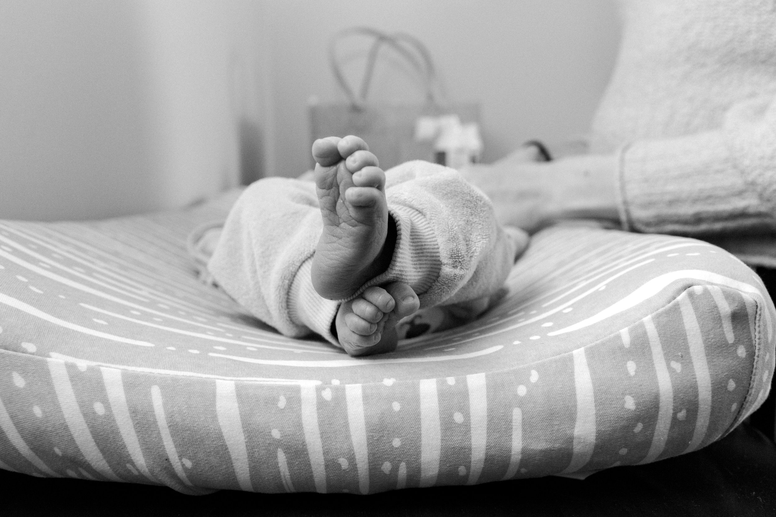 black &amp; white photo of baby on changing table