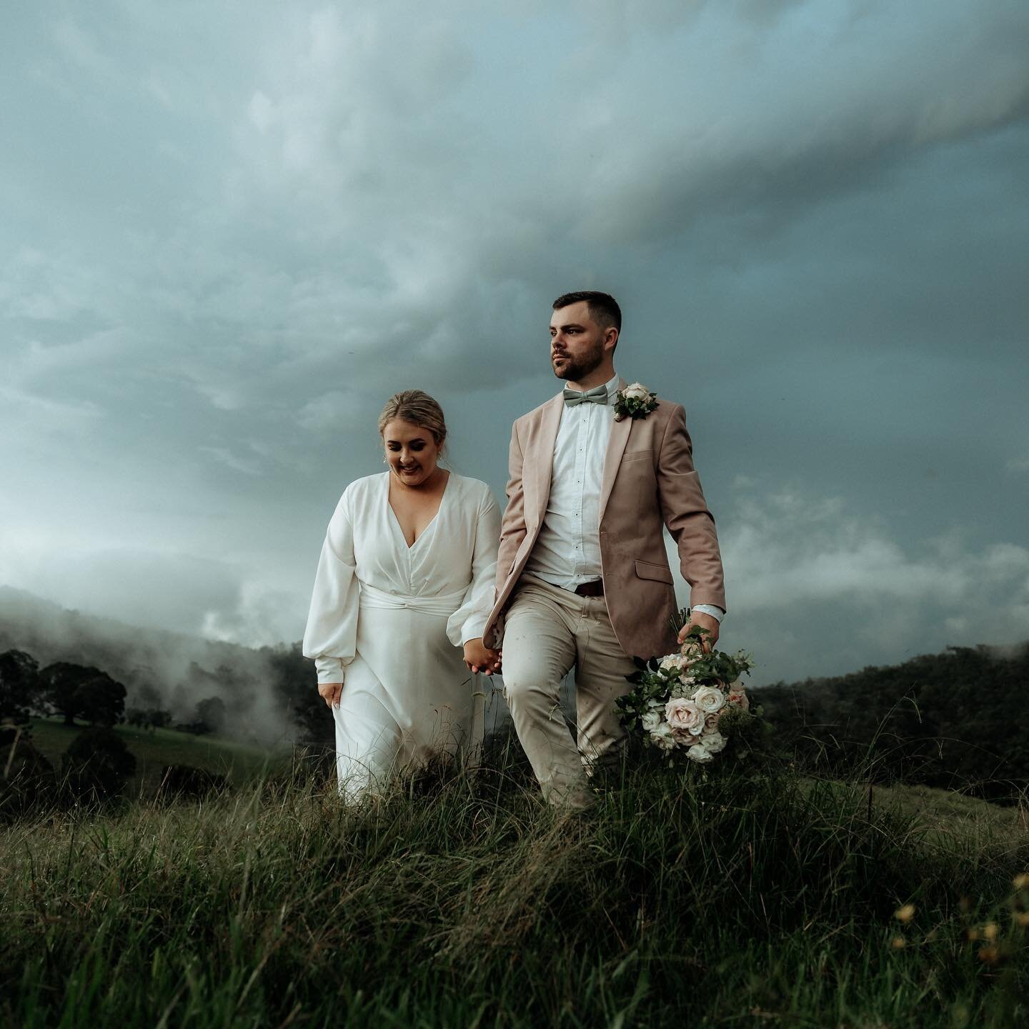 Trudging through wet grass, Sammy and Jake get their reward with some dramatic scenery complete with silver lined clouds. Congrats guys, thanks for persevering in the rain. 
.
. 
. 
. 
#couples #dramaticlandscape #wetwedding #goldcoastweddingphotogra