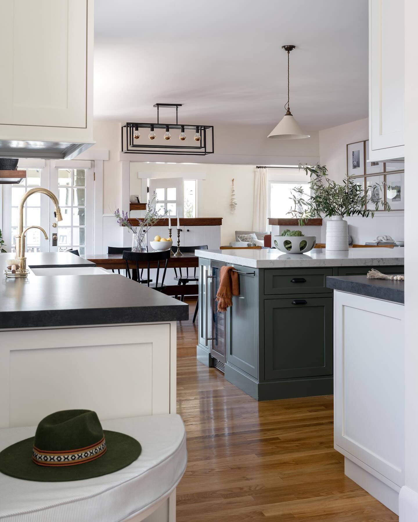 A view from the kitchen through the dining room and living room in the very back. Each feels like its own space yet connected. Swipe to see the before of the same view.

Project #StayInDouglas
Build @jenksdesignbuild 
📷 @charlotteleaphotography 
.
.