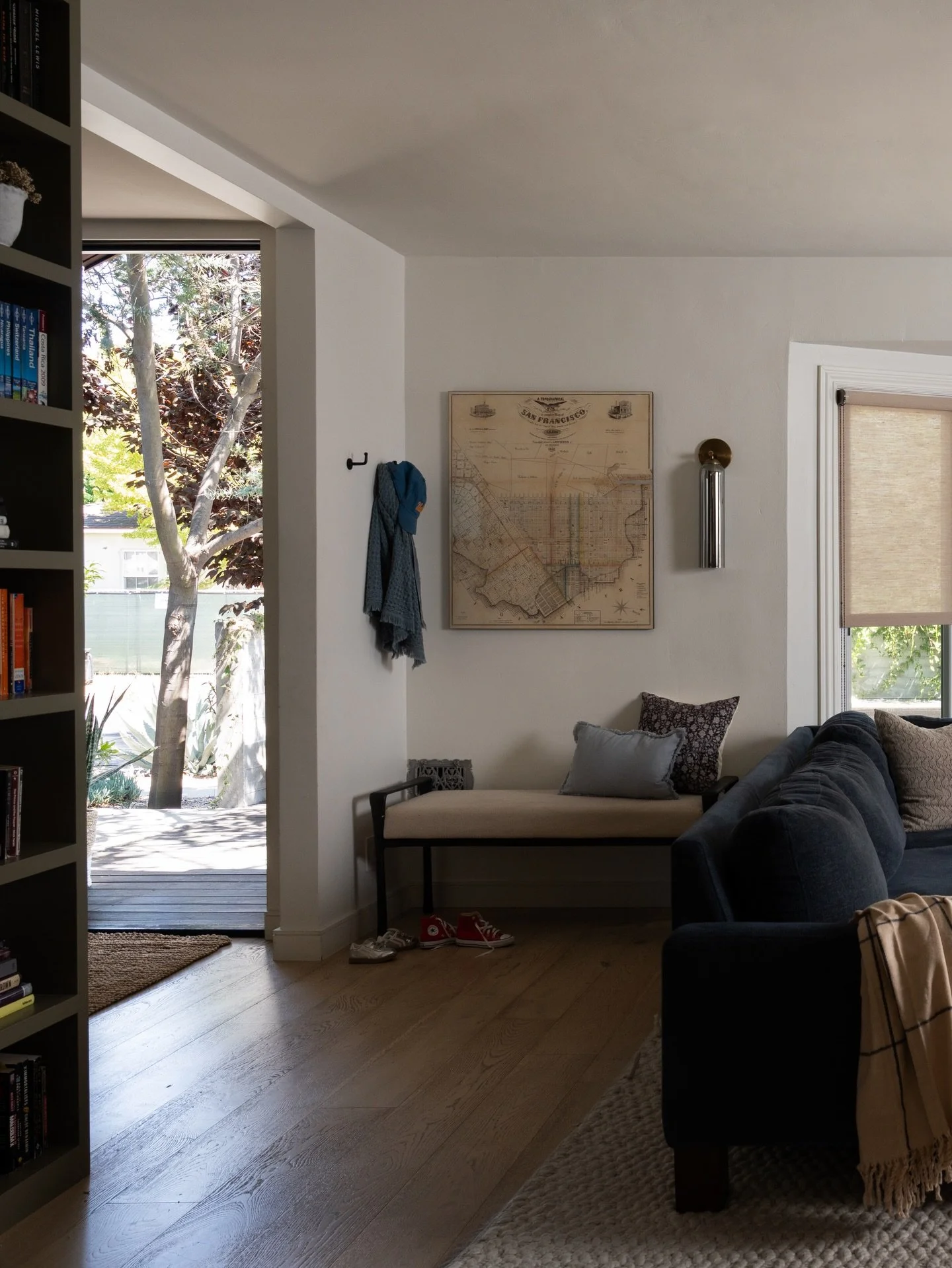 Wanna know a design tip? Warmth comes from layering, not just color.

In this living room, we combined a deep blue-toned sectional, varied textures, unique lighting, and custom window treatments to create a space that feels both elevated and lived-in