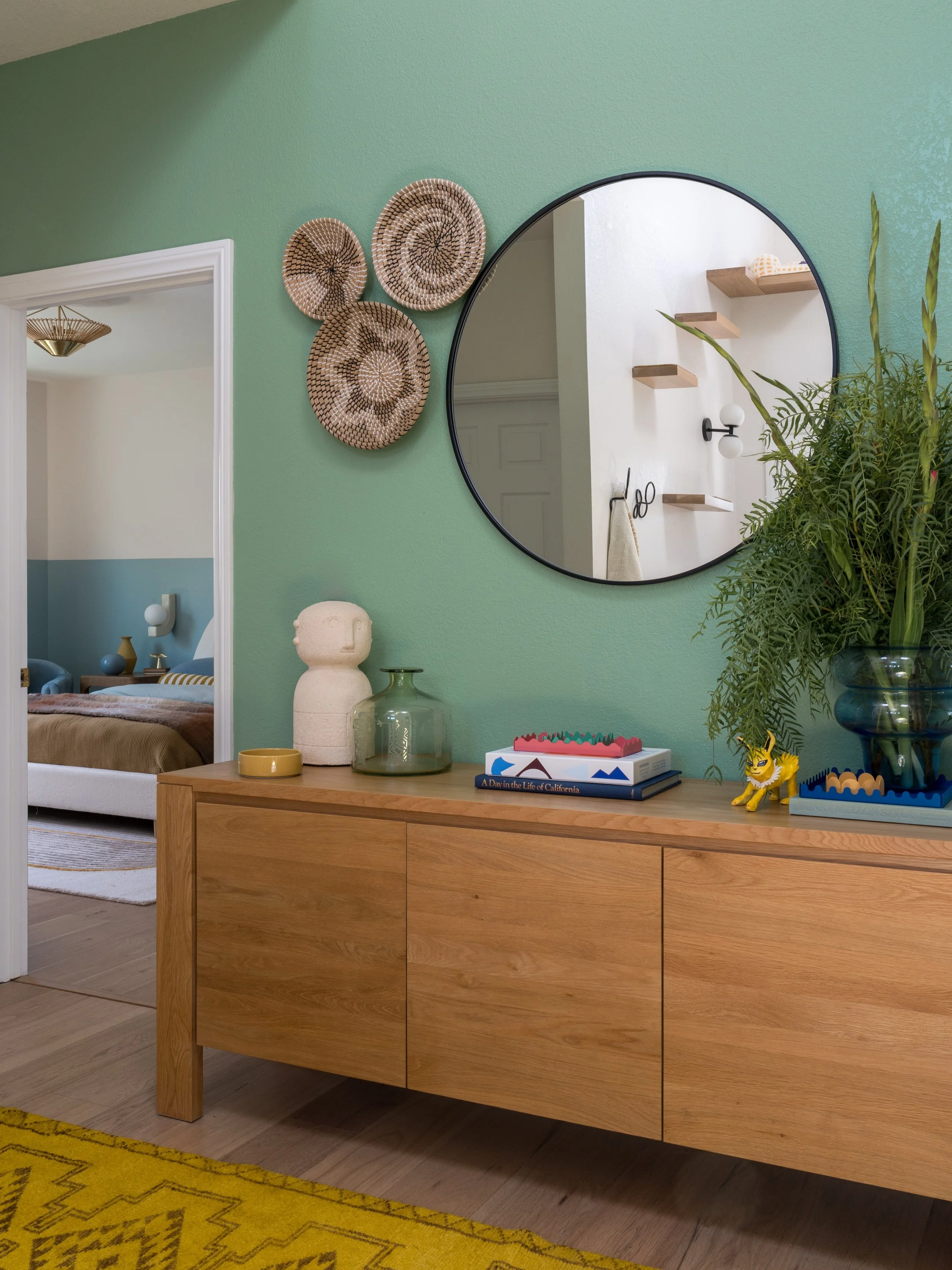Part of the process is helping clients refine what they love into something that feels cohesive and intentional. These clients were drawn to lots of color, but needed guidance shaping it into a clear story throughout the home. So we layered soft gree