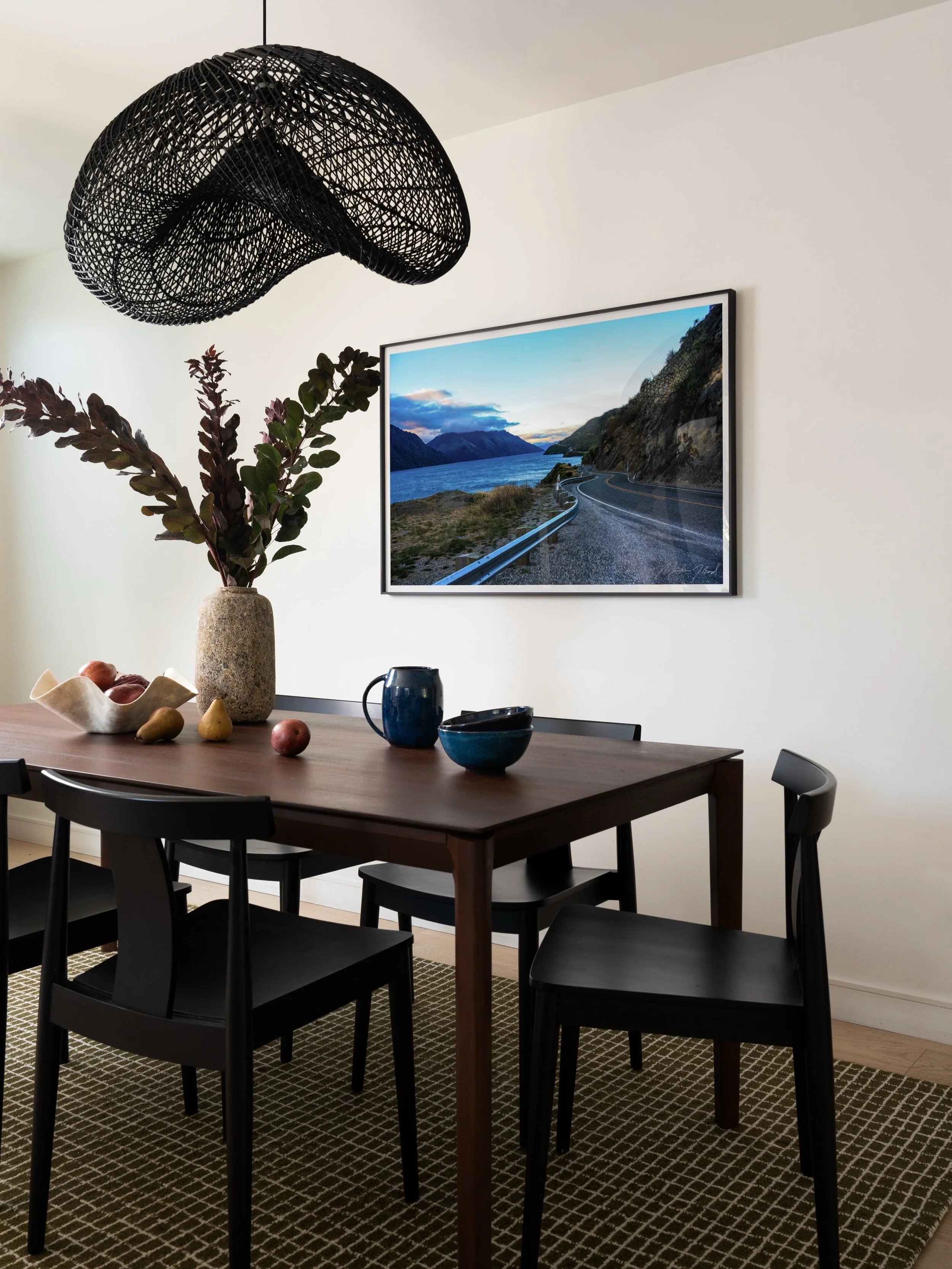 Thoughtful details make all the difference! The dining room of this Leimert Park home in Los Angeles combines a sculptural light fixture, a rich green rug, oversized photography, and warm wood textures for a space meant to gather everyday.

From full