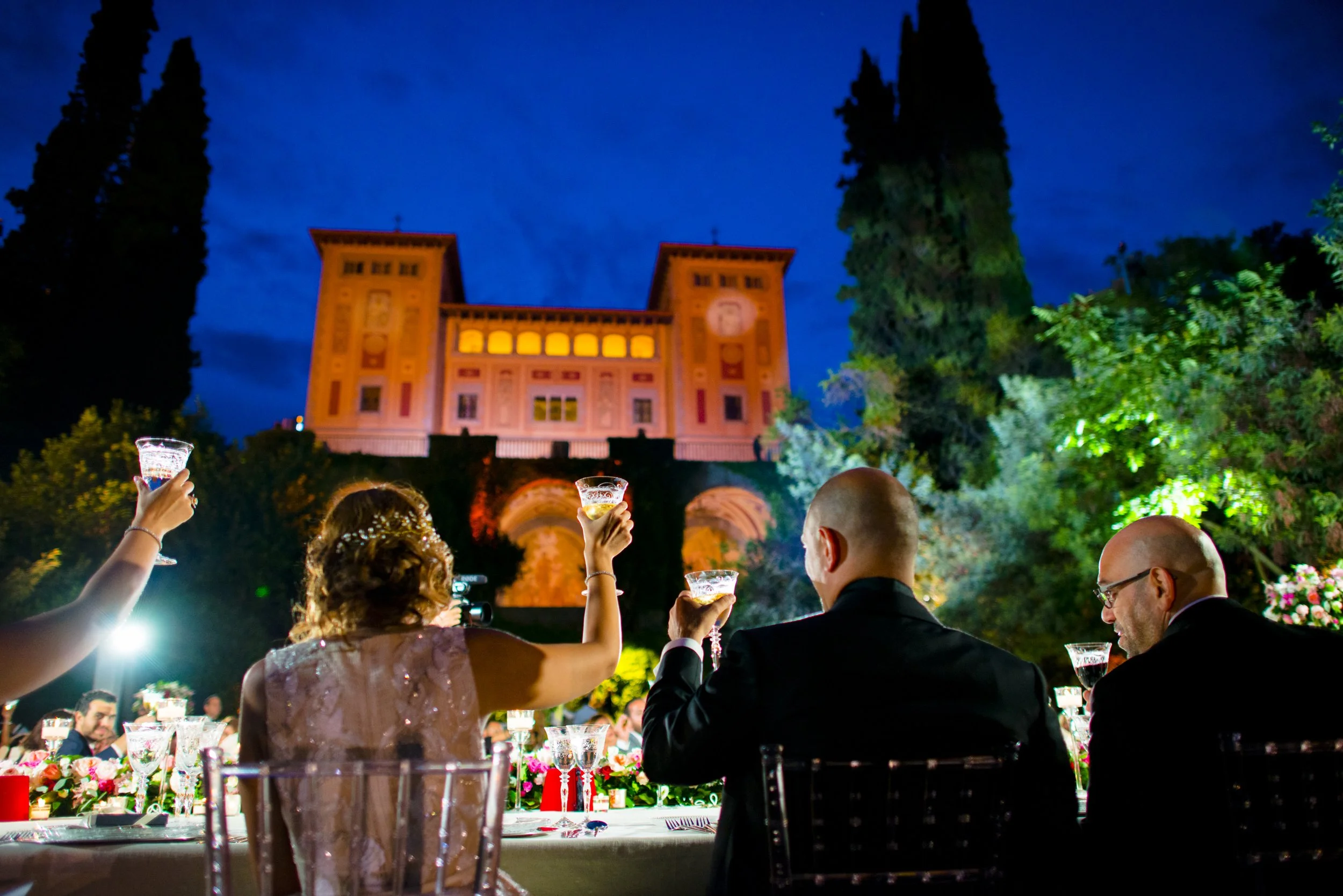 Grand wedding reception dinner at Bell Recó Barcelona with the illuminated facade in the background, captured by Orlando Rivera