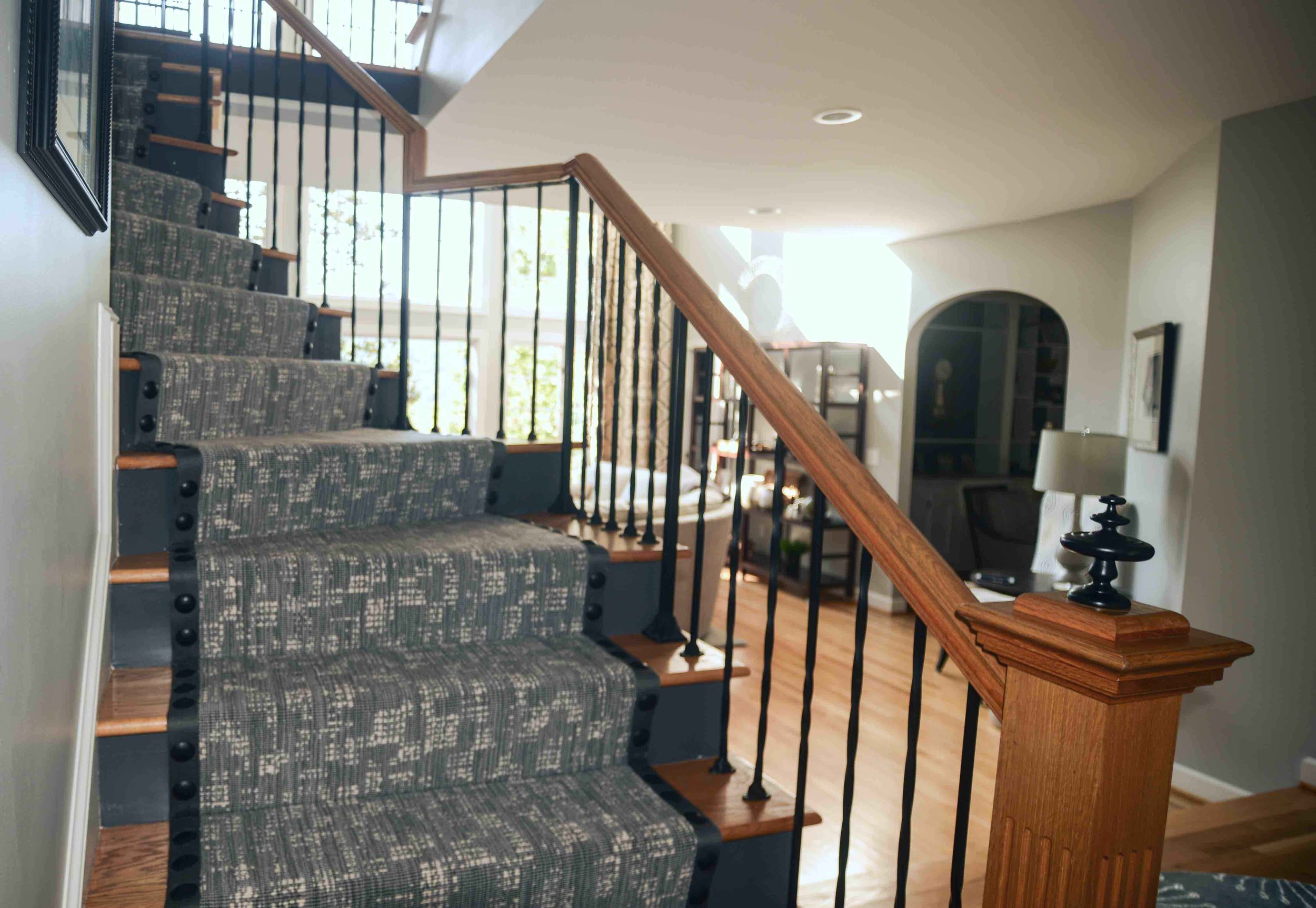 180 Spaces | Interior Design Turnarounds -  Curved stair detail featuring banded carpet runner with enlarged, hammered nail head trim. @Stark Carpet