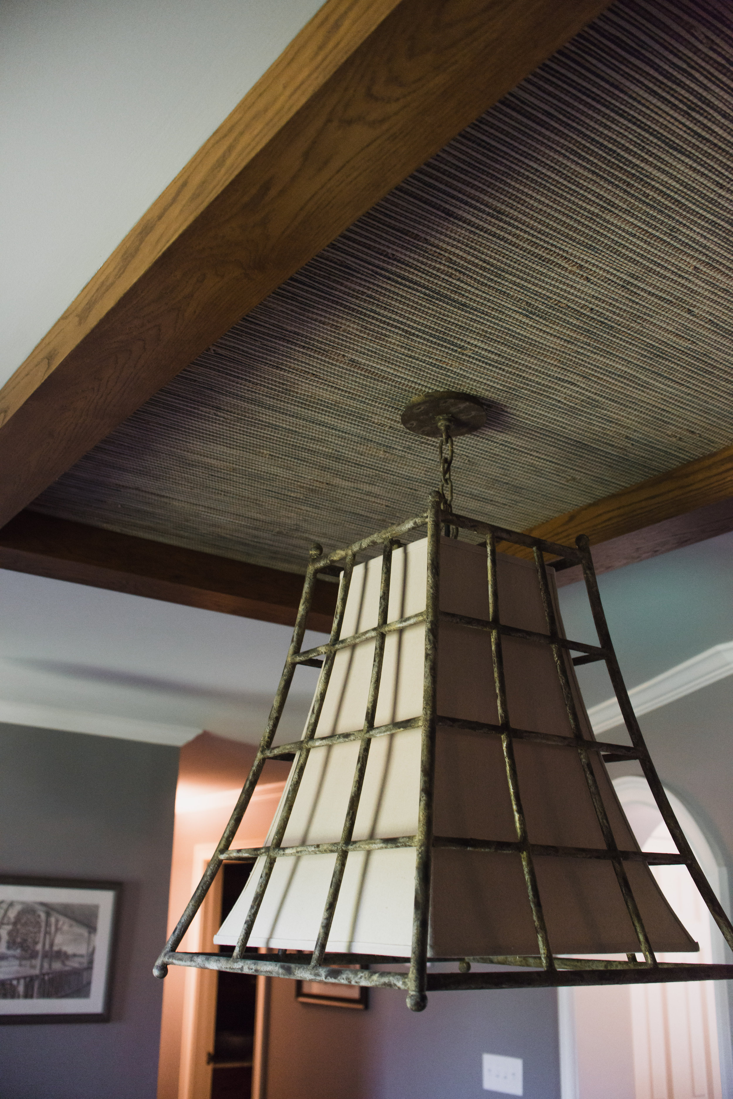 Faux ceiling tray for dining room remodel featuring cedar wrapped beams with grasscloth inset. Designed by 180 Spaces, NC Lake Norman Interior Designer.