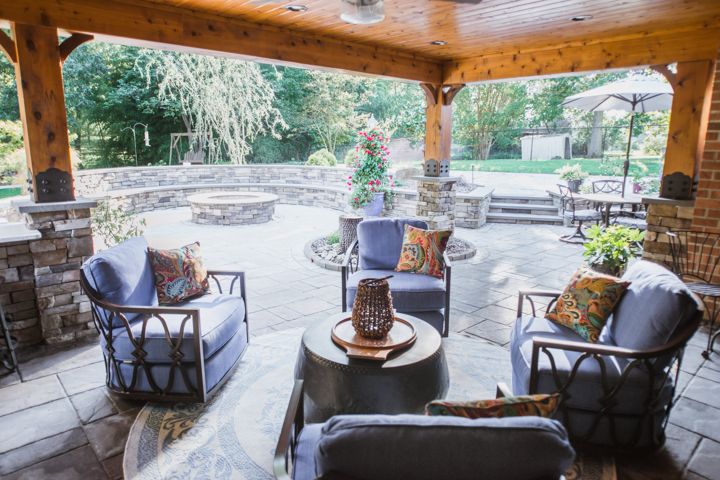 Outdoor lanai design featuring custom red cedar posts and Lexington Furniture swivel club chairs. All design by NC Lake Norman Interior Designer, 180 Spaces.
