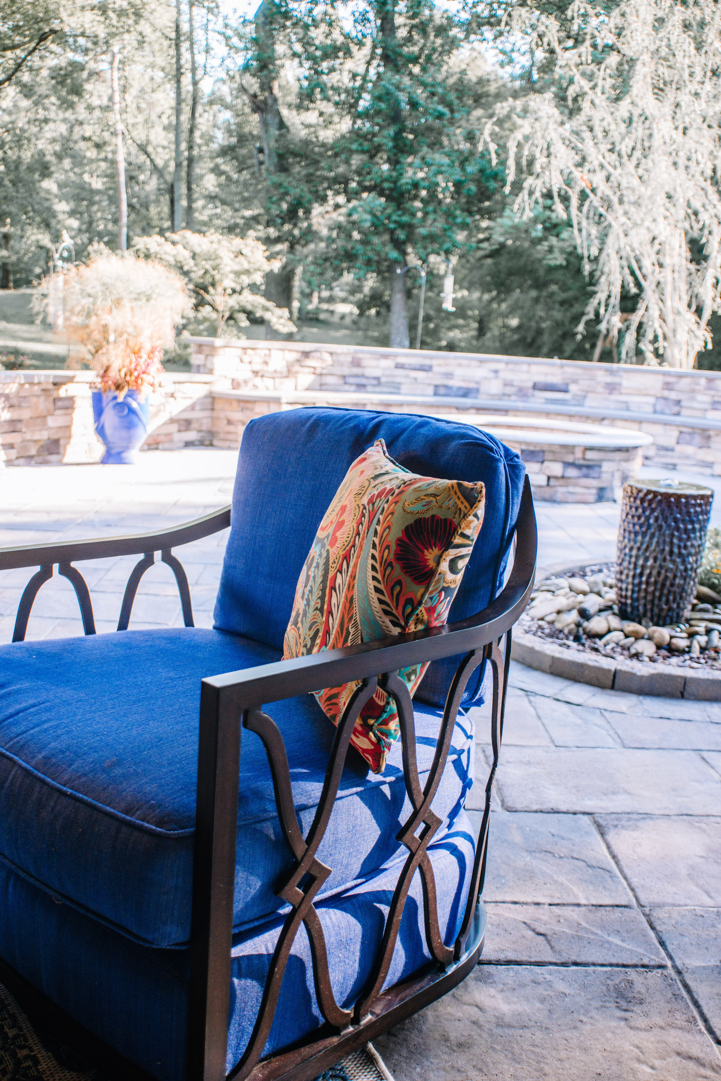Outdoor lanai seating area featuring Lexington swivel club chairs. Design by NC Lake Norman Interior Designer, 180 Spaces.