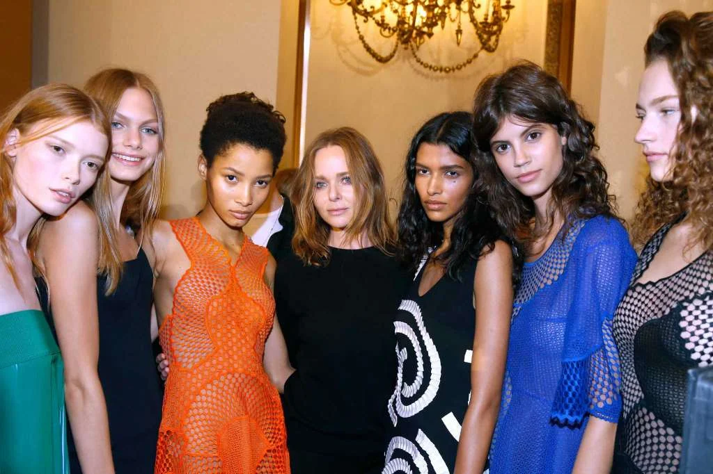 Designer Stella McCartney, center, and her models pose backstage after the Stella McCartney show as part of the Paris Fashion Week Womenswear Spring/Summer 2016. Stella McCartney whips out her cellphone to snap a selfie in front of the Tom Ford store at River Oaks District. She's tickled that she and Ford, a Dallas native and a close friend, have storefronts in the luxury retail development within walking distances of each other. She texts him the photo. "I'm seeing people walk around with my bags, and I love it," says McCartney, who was in Houston last week for the official grand-opening party for her store. "It's funny ... you don't realize how fortunate you are to open a store. There's so much that goes into it. It has to be the right timing, and everything has to line up. This was the time that everything lined up to have our store here." McCartney's first Houston outpost, which had a soft opening in October, is her seventh U.S. store and one of 45 locations worldwide, including London, New York, Los Angeles, Paris, Milan and Tokyo. McCartney, 44, says her busy home life with husband Alasdhair Willis and their four children - ages 5, 8, 9 and 11 - means she doesn't do many "road shows," but she tries to visit when she can. (One of her favorite things to do with her children, she says, is to "look at them and smell them. I'm obsessed with their breath in the morning, which is terrifying.") Before the Houston visit, McCartney was in Los Angeles and decided to check on things at the store there. "Sometimes I go in (unannounced) and say, 'Hi' and everyone freaks out," she says. It's that unassuming quality - and her unbridled talent as a designer - that McCartney is known for. She's not caught up in celebrity; her dad is a music legend, after all. For her, life in the spotlight comes with much humility. More