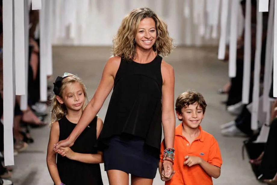 Designer Michelle Smith walks the runway at the Milly By Michelle Smith show during Spring 2016 New York Fashion Week at Art Beam on September 15, 2015 in New York City. (Photo by JP Yim/Getty Images) Michelle Smith's long, blond mane - and the blowouts to straighten it - had been a part of her world since she launched her Milly brand in 2001. But last year, she decided her hair was weighing her down. So after a photo shoot for her latest collection, Smith told celebrity hairstylist Yannick D'Is to "do whatever you want to do to my hair." He chopped off nearly 10 inches and left her with a glamorous cut with natural curl. "I was so ready to go back to my curly hair. It was time. Maybe it was about feeling more confident," said Smith, 43, who recently was in Houston for the Children's Assessment Center annual Spirit of Spring Luncheon and Fashion Show at the Royal Sonesta Hotel. The event featured a Neiman Marcus runway show of her collection. Smith is also feeling more romantic these days. Her spring and summer "Modern Love" collection is a sensual mix of soft details and structured design with off-the-shoulder blouses, flirty and ruffled dresses and cascading skirts in hues from sunrise to sunset. The designs come from a more personal place, she said, taking hearty fabrics such as denim and cotton shirting and making them feminine and playful. More
