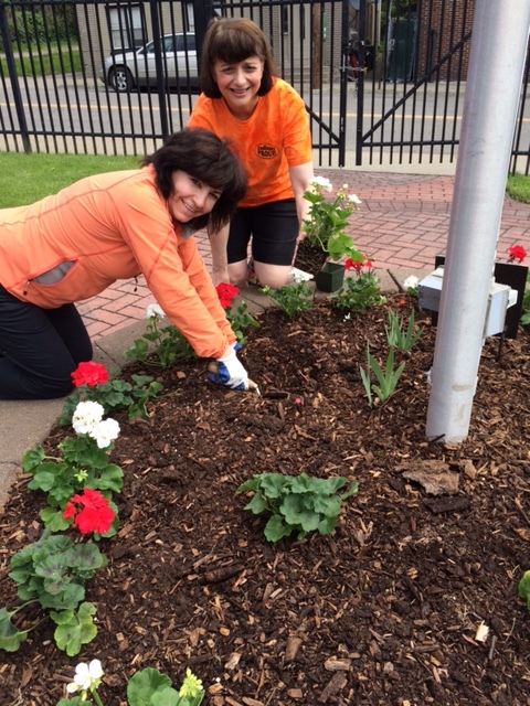Lisa Lee, CEO of North Point Technology, LLC (left) helps plant flowers during the Endicott Proud Village Clean Up Day on May 20, 2017. 