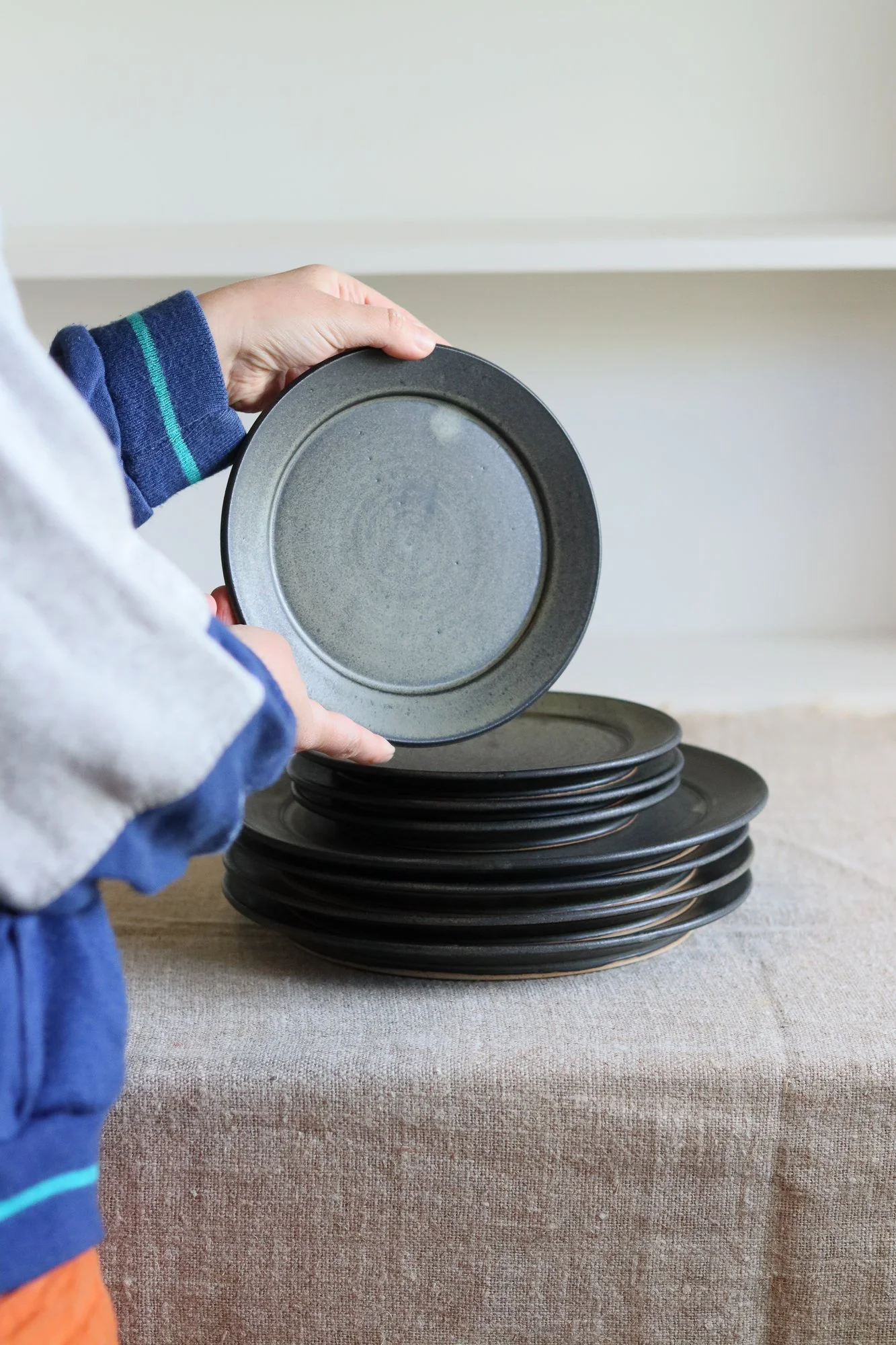 Stoneware side plate thrown at the wheel and glazed in a matte black glaze