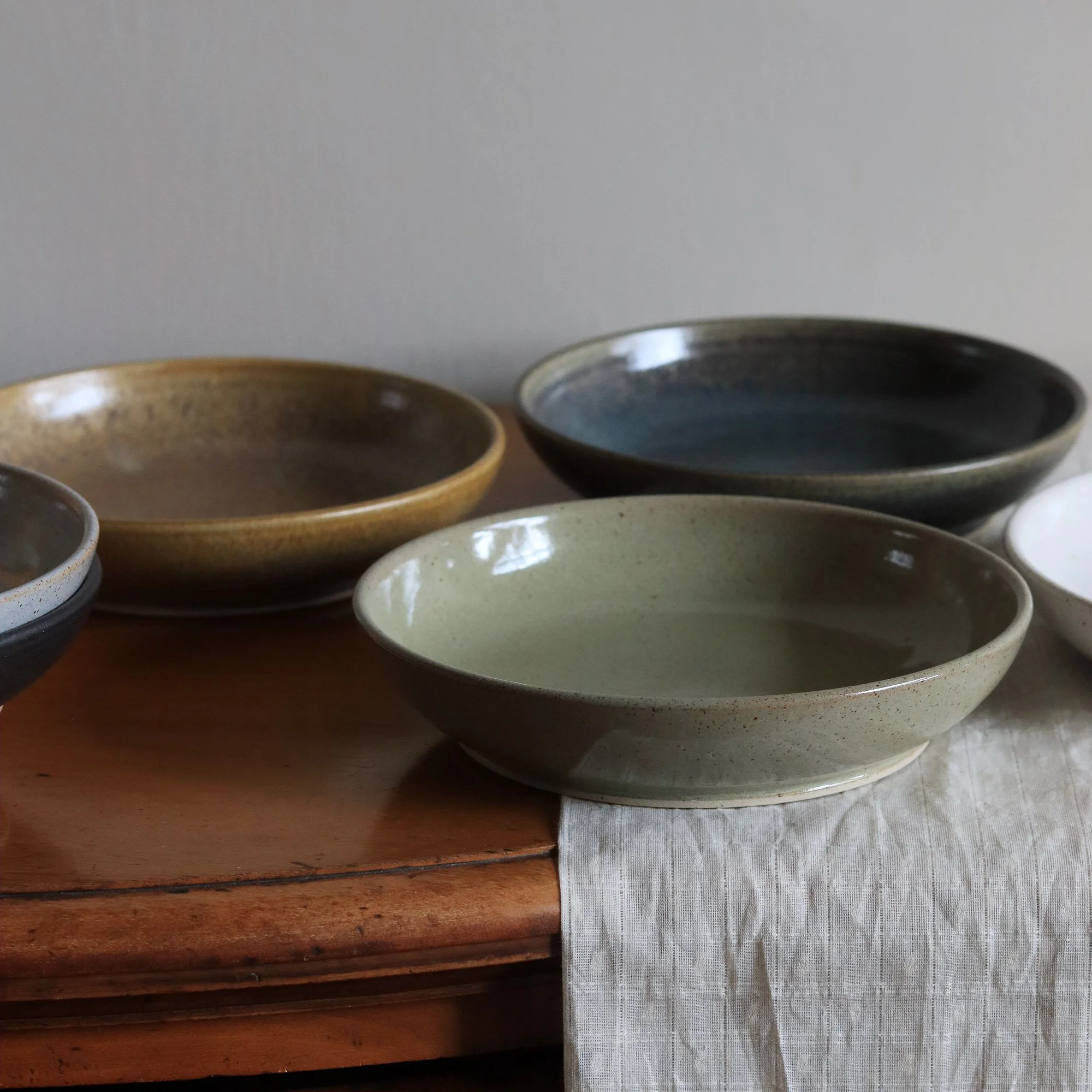 Subtle colourways in the glazed shallow dishes handmade by Pottery West