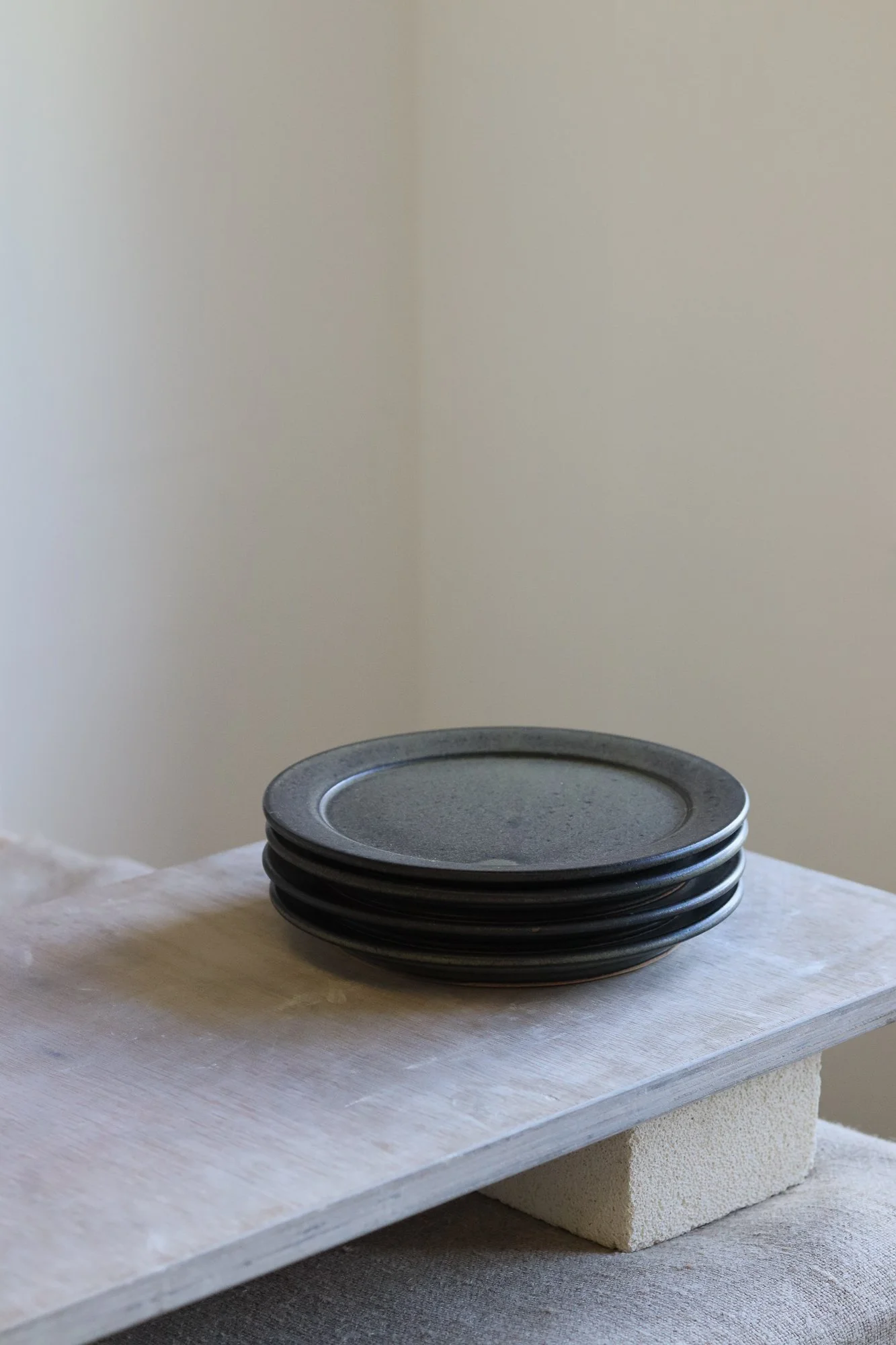 Stoneware side plate thrown at the wheel and glazed in a matte black glaze