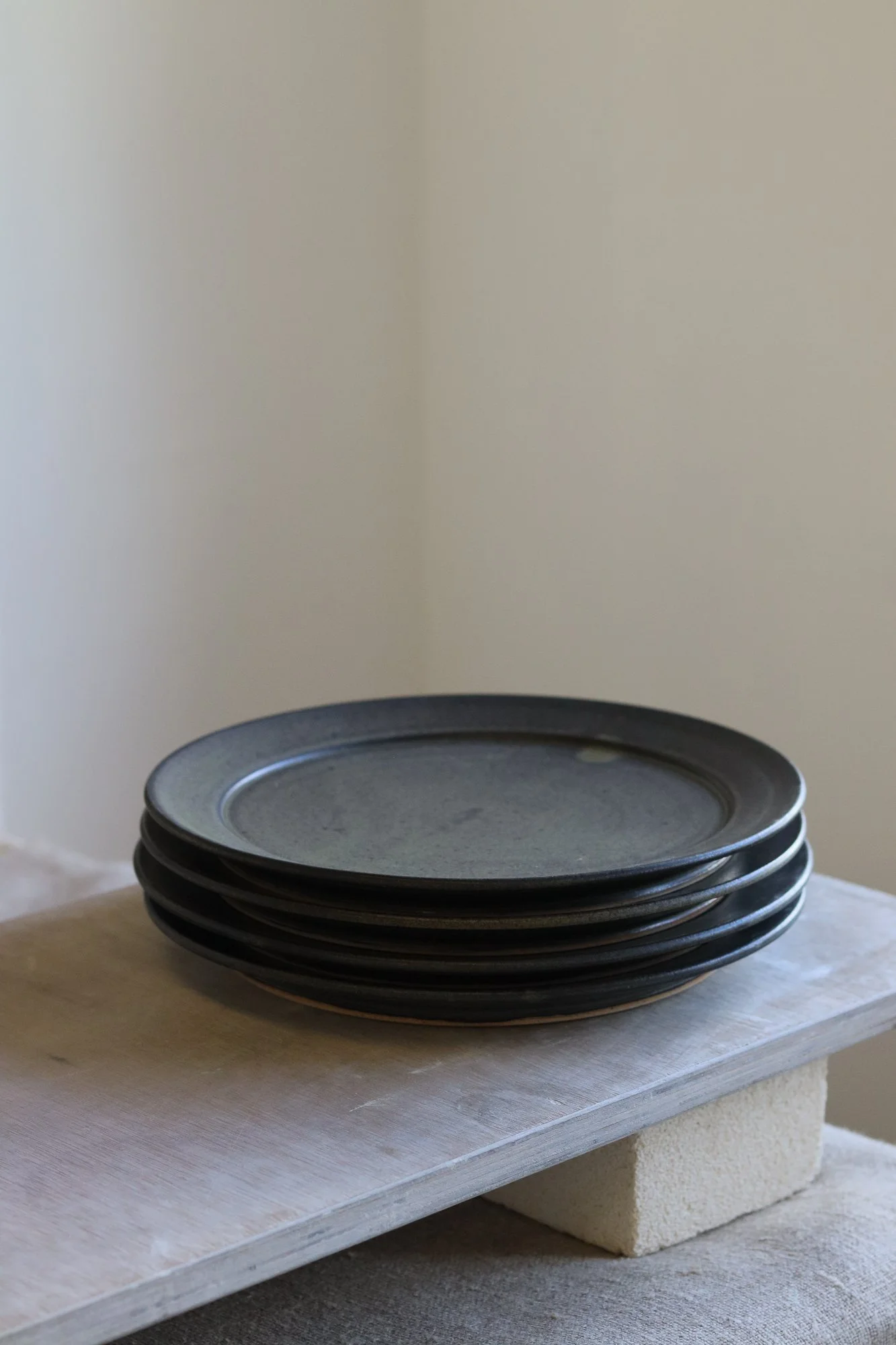 Stoneware side plate thrown at the wheel and glazed in a matte black glaze