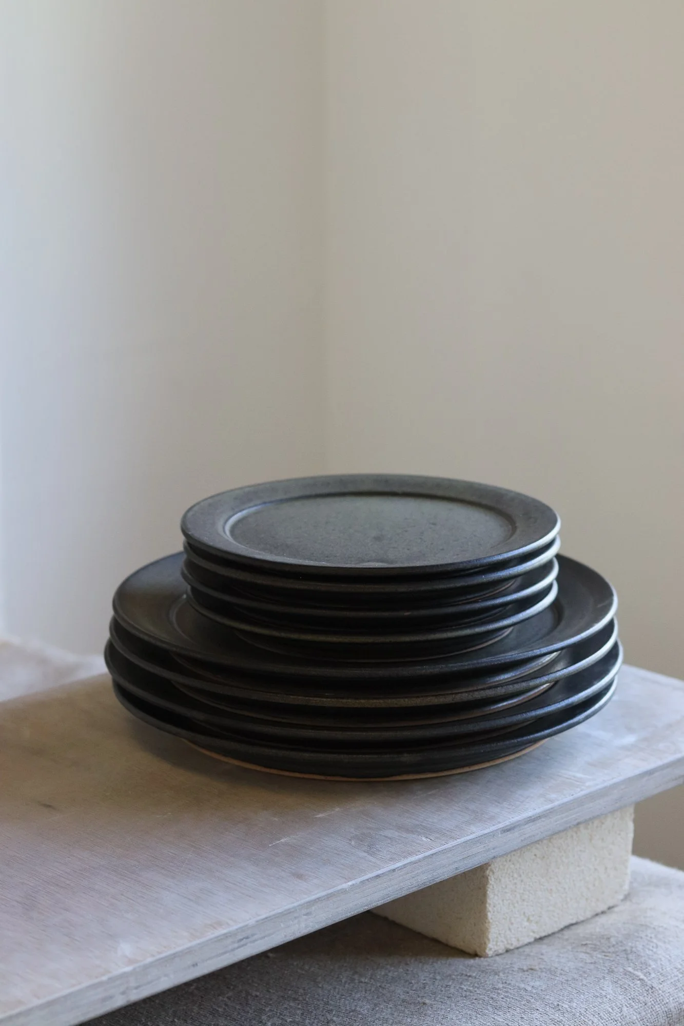 Stoneware side plate thrown at the wheel and glazed in a matte black glaze