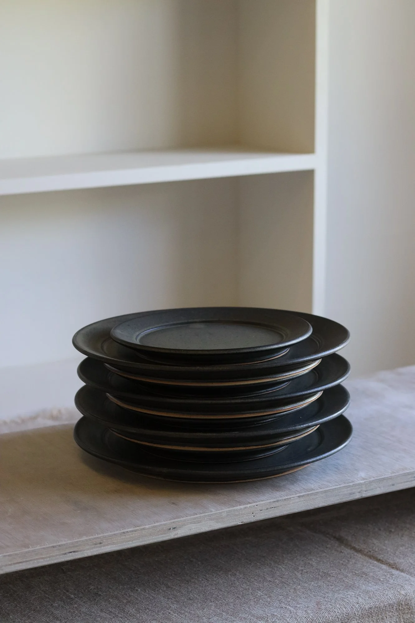 Stoneware side plate thrown at the wheel and glazed in a matte black glaze