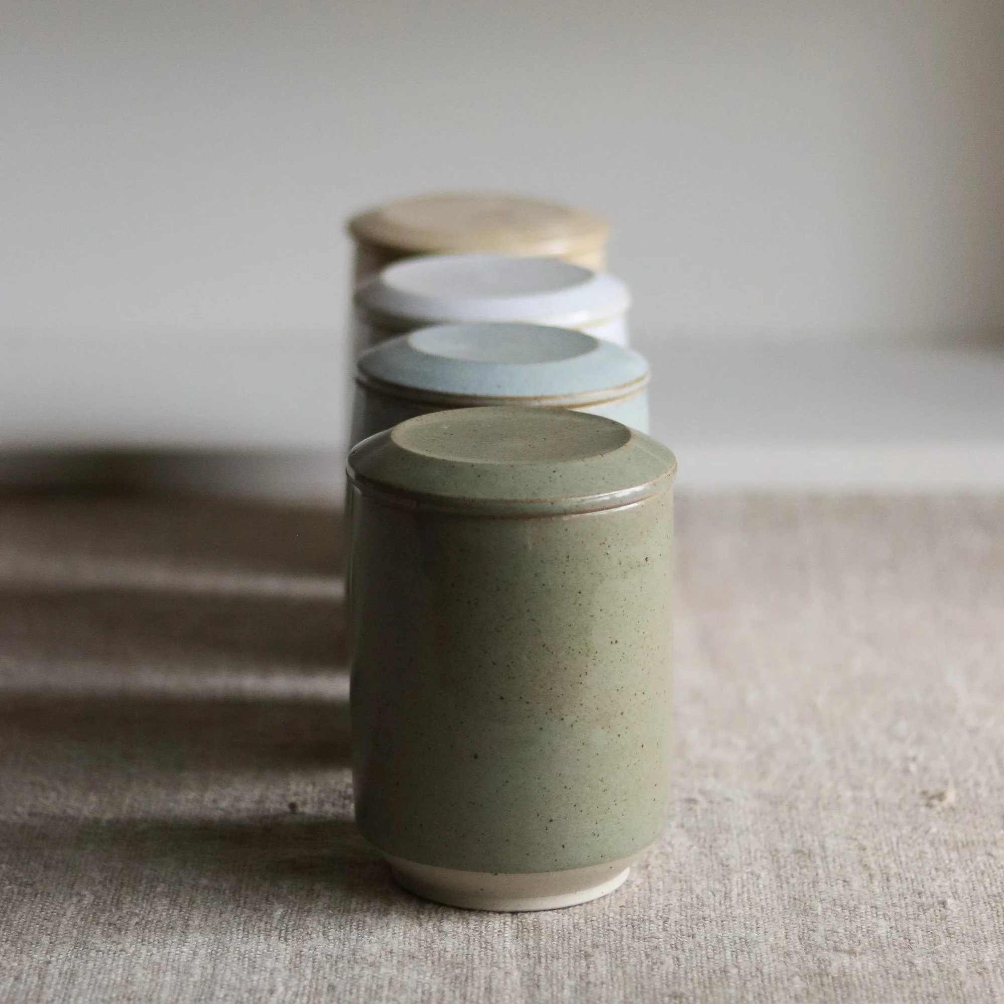 Row of lidded jars by Pottery West handmade in the UK by Catherine and Matt West
