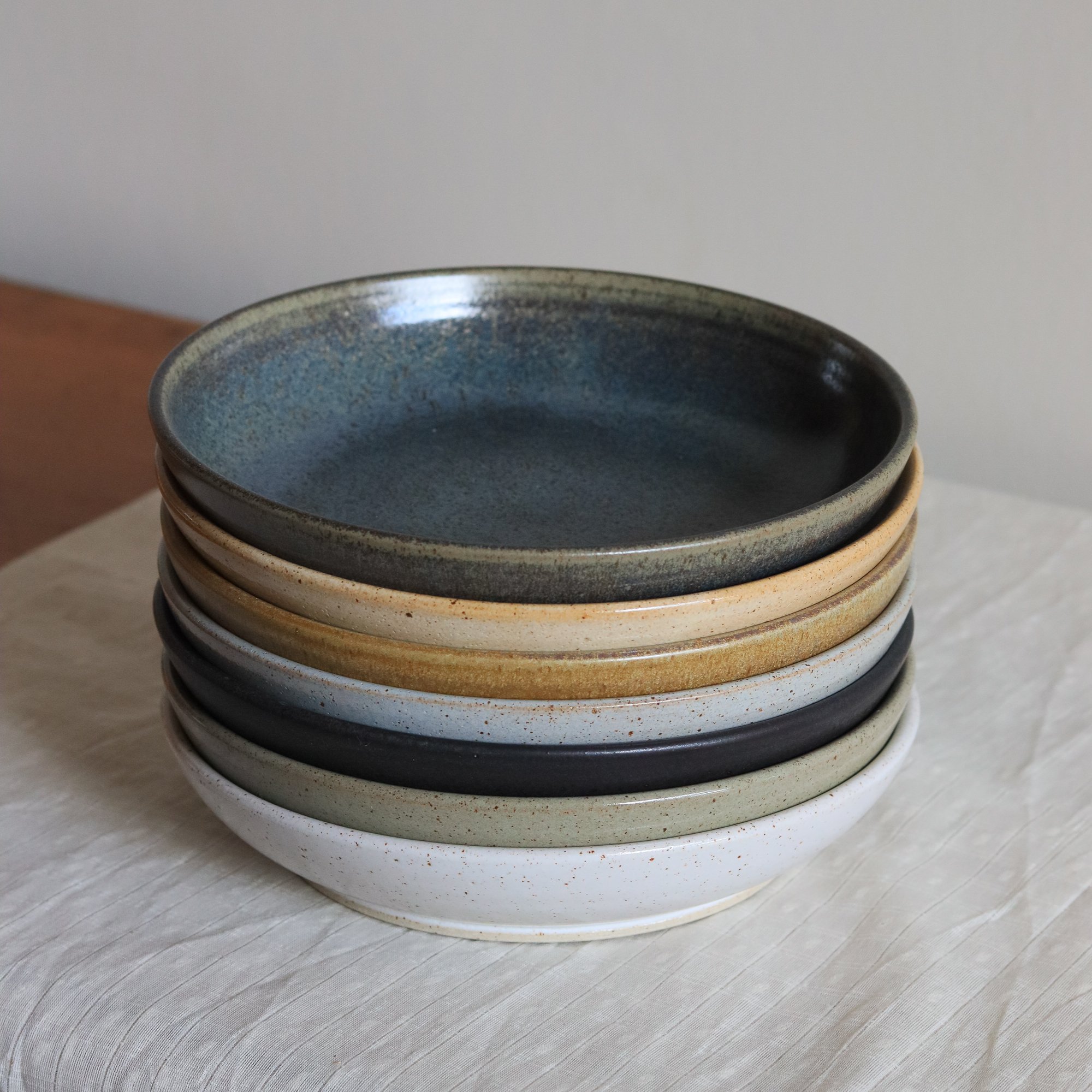 Stack of handmade dinner bowls by Pottery West, handmade at the potter's wheel