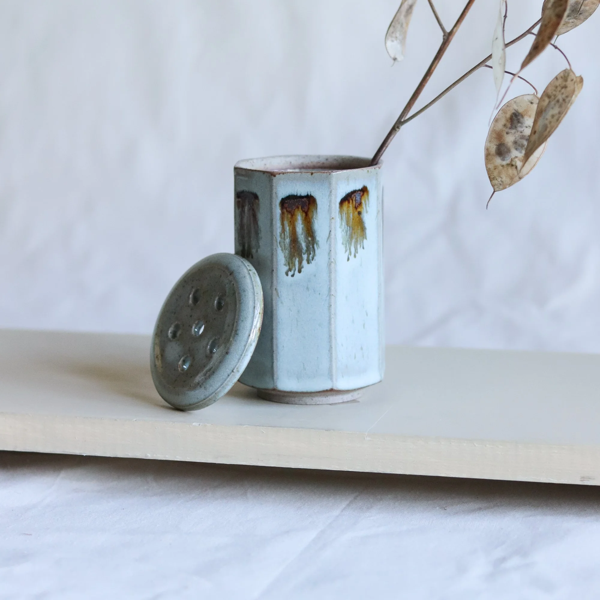 Stoneware flower frog vase in pale blue chun made by Pottery West in Sheffield.
