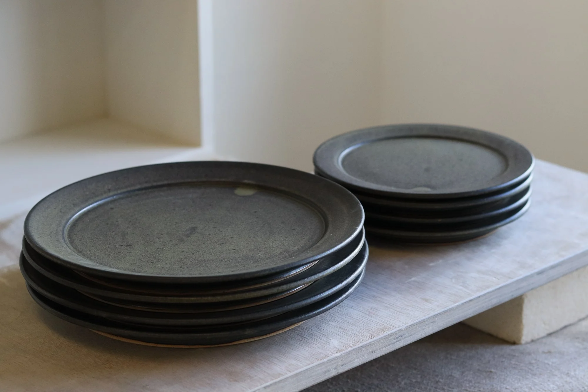 Stoneware side plate thrown at the wheel and glazed in a matte black glaze